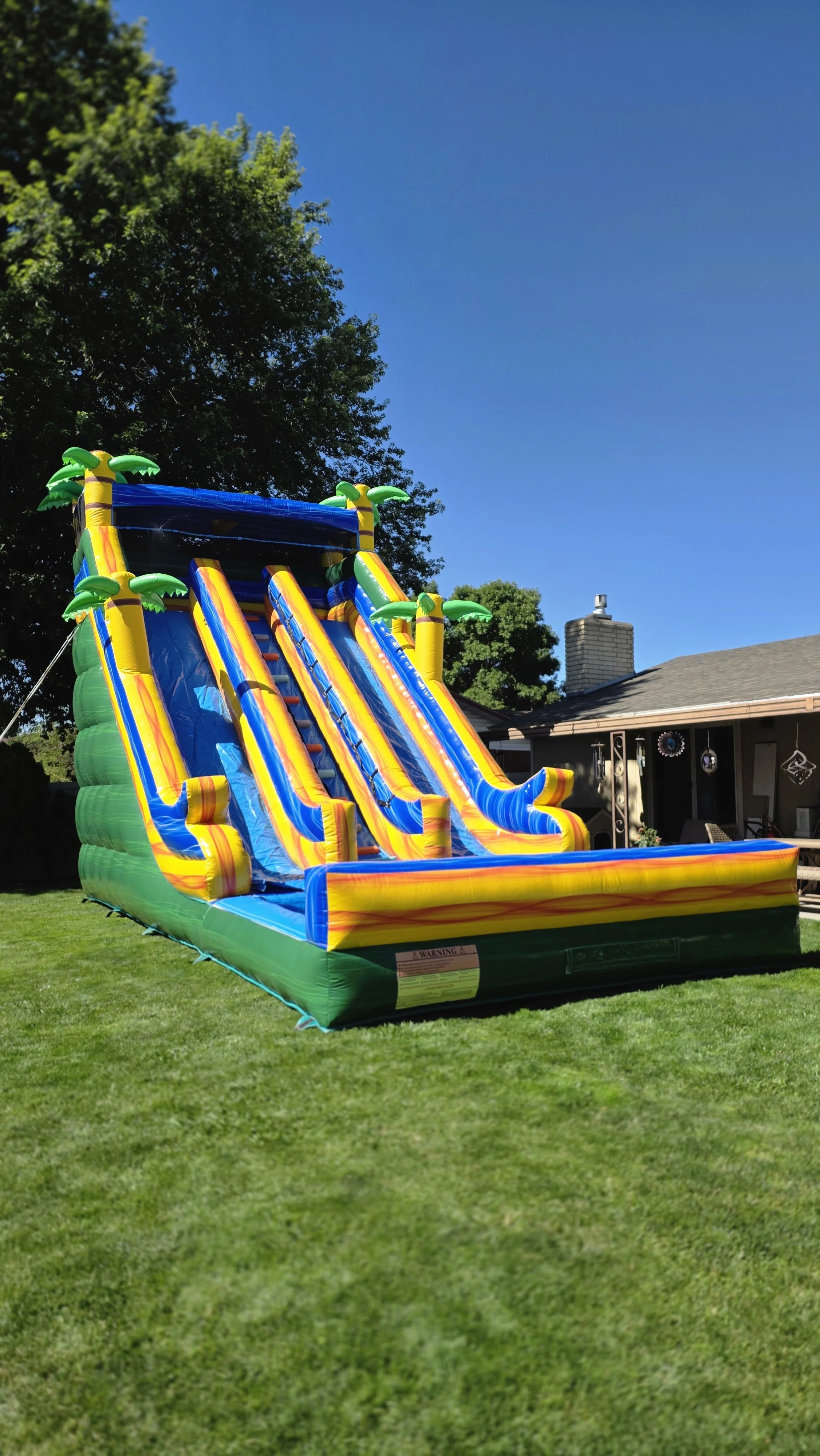 Extra-large Pompeii tropical waterslide set up in a backyard, available for rent in Richland, Kennewick, Pasco and surrounding Tri-Cities communities.