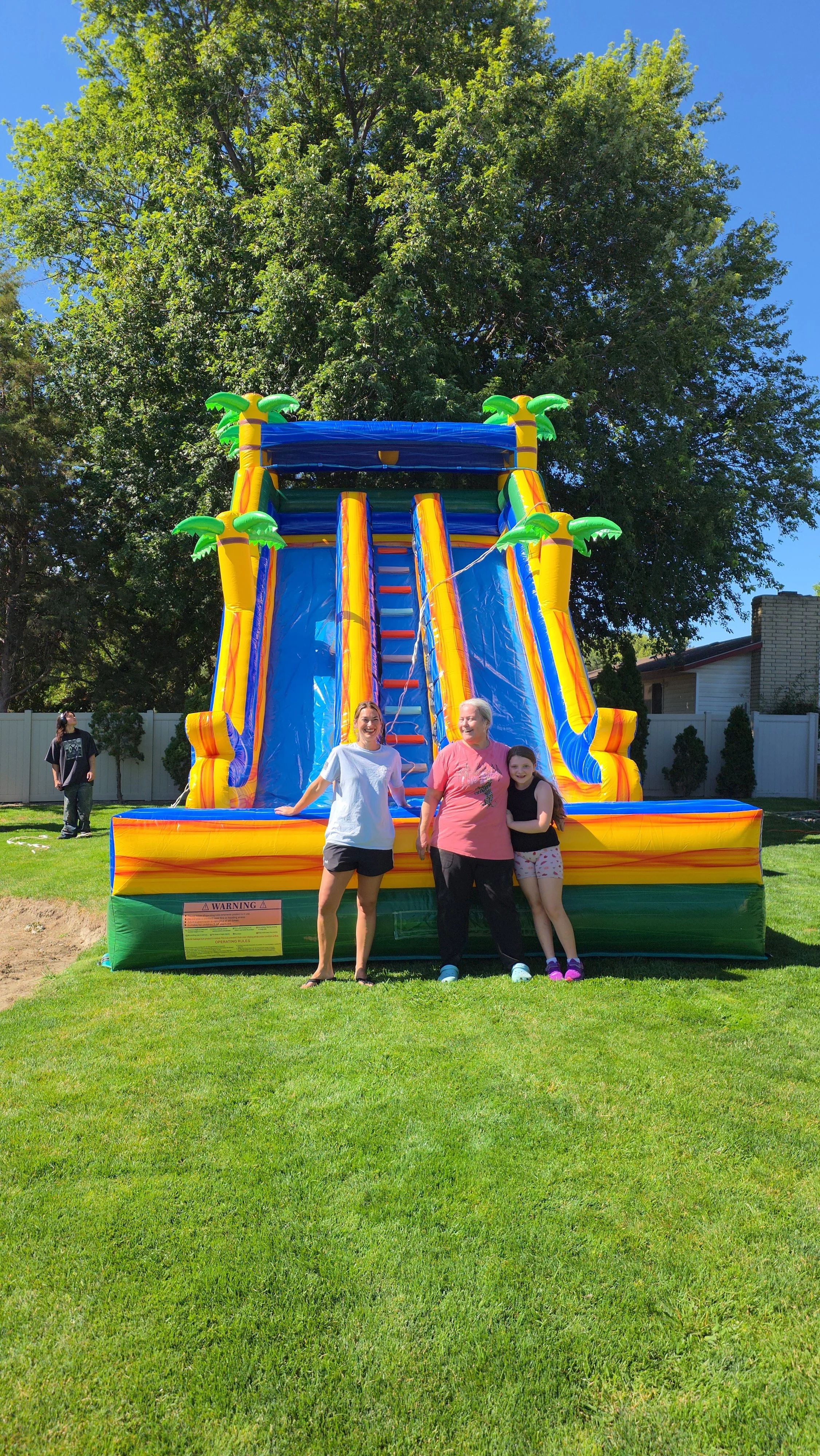 Extra-large Pompeii inflatable waterslide for rent in Richland, Kennewick and Pasco, WA. Featuring two racing lanes, tropical palm trees and a huge splash pool.