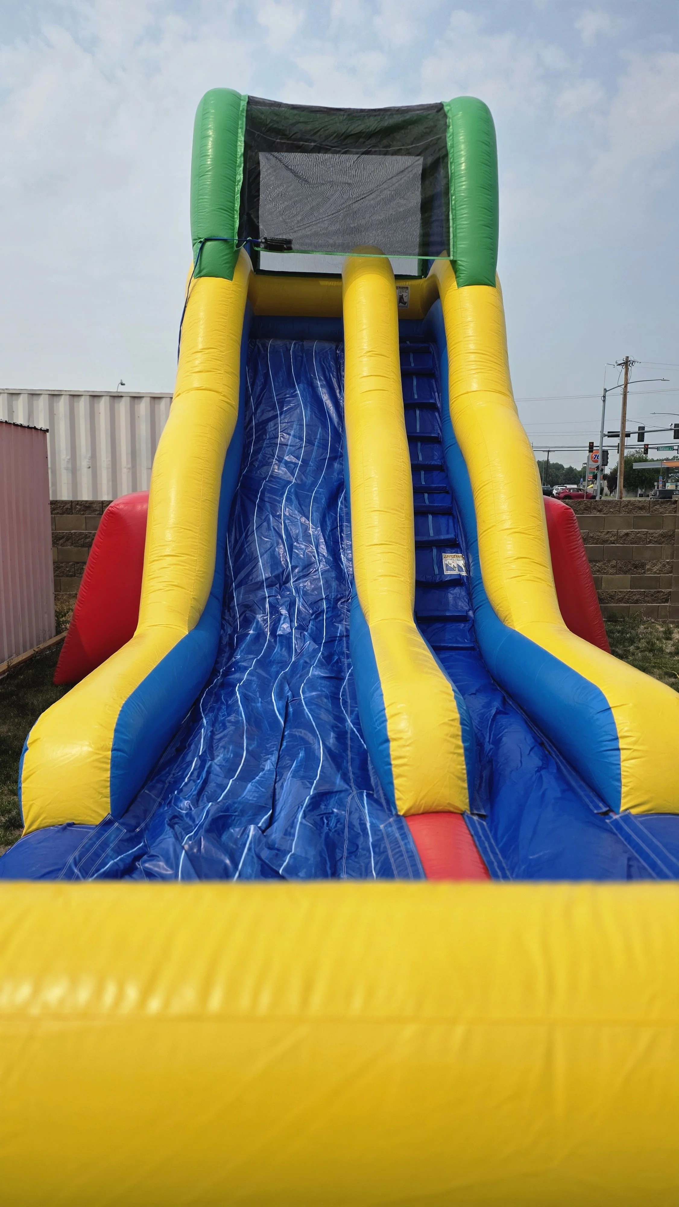 Flip Flop inflatable waterslide photographed outdoors, showing its tall colorful slide structure for summer parties in Kennewick, Pasco and Richland.