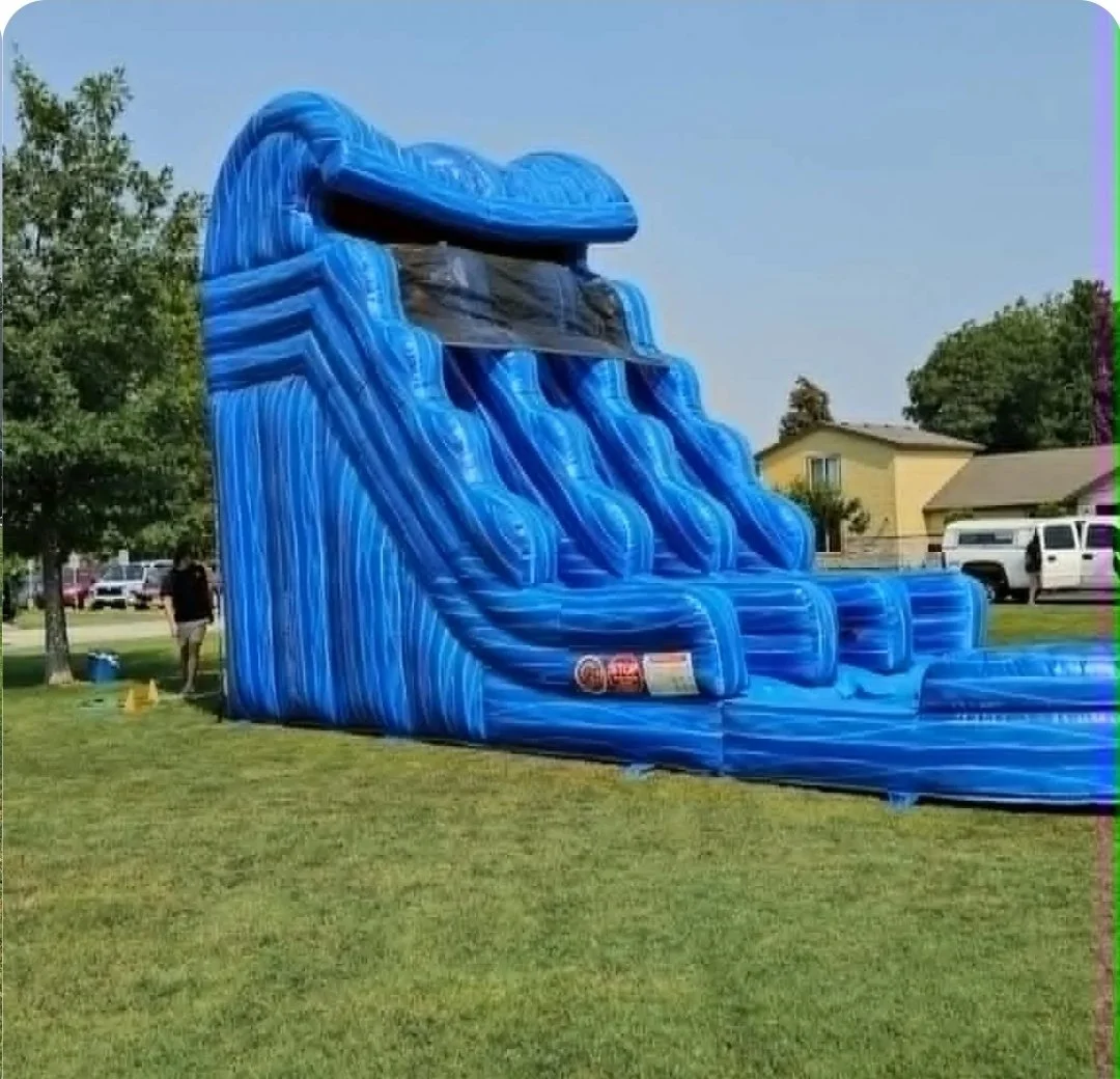Side view of the massive Double Trouble blue inflatable waterslide with two sliding lanes and a splash pool, available for parties in Richland, Kennewick and Pasco, WA.