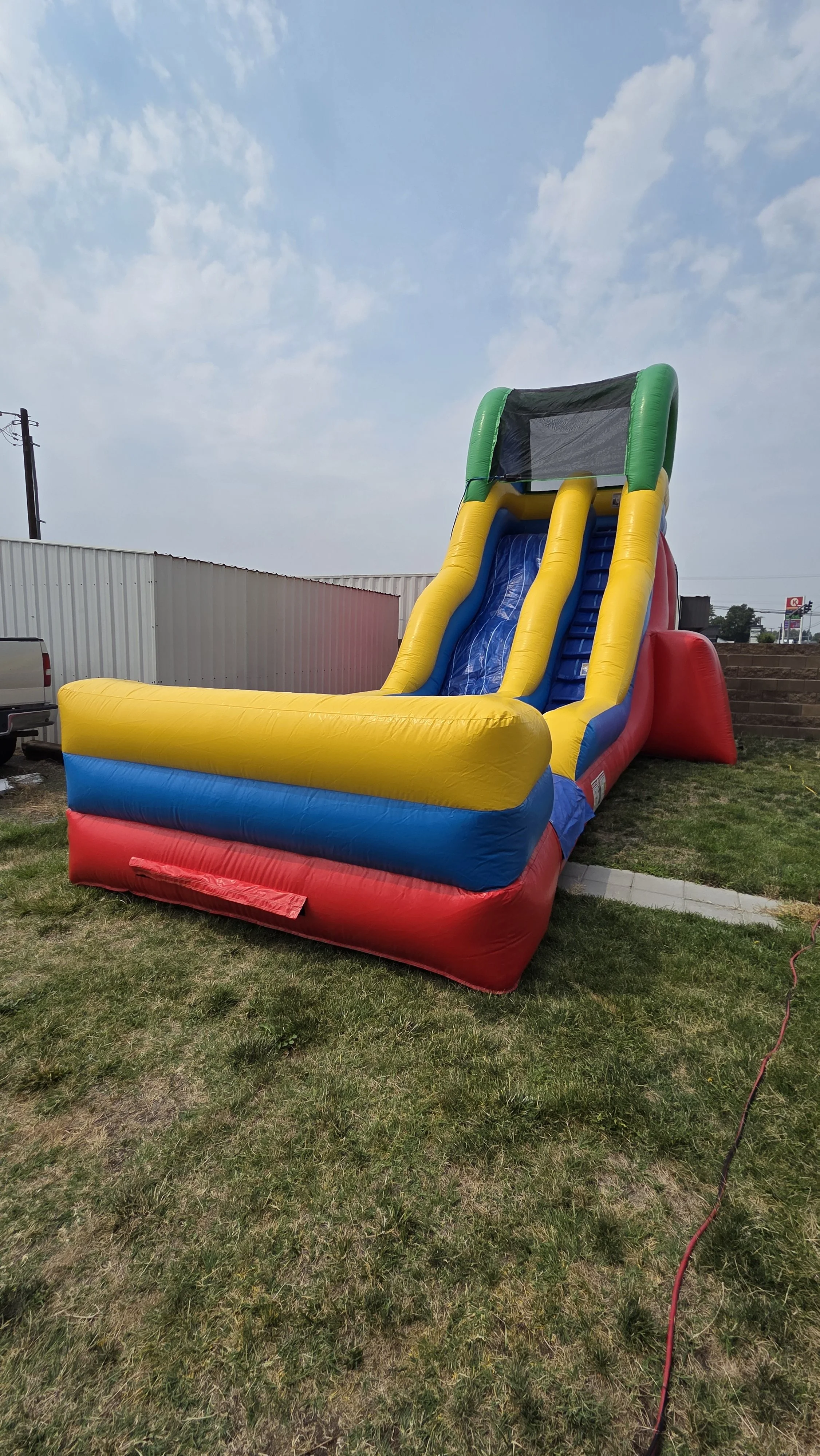 Flip Flop colorful inflatable waterslide set up on a grassy lawn for backyard parties and summer events in Richland, Washington.