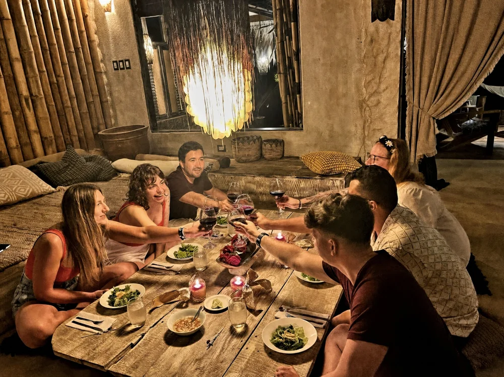 Guests sharing dinner around the long table at Casa Del Soul