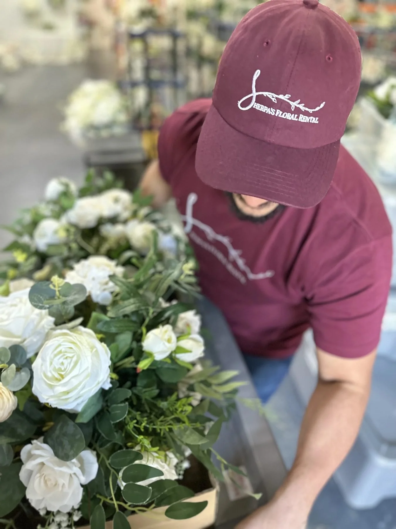 Sherpa's team member arranging white roses