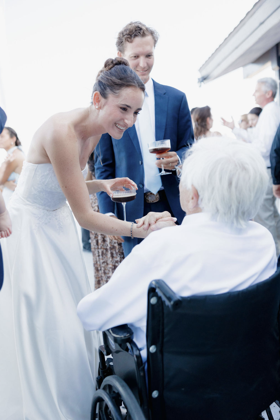 Beautiful bride Melody greeting guests at Mission Bay Yacht Club.