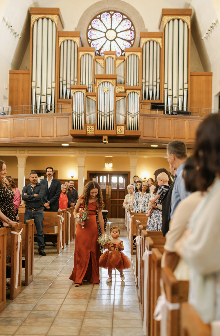 Flower girl at Holy ceremony at Saint Brigid Parish Pacific Beach.