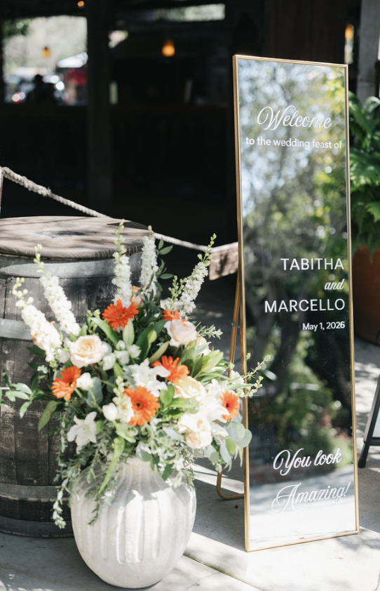 Reception florals and welcome sign at Bernardo Winery.