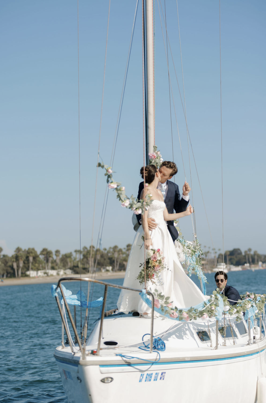 Grand entrance on  floral decorated vintage sail boat to Mission Bay Yacht Club. 