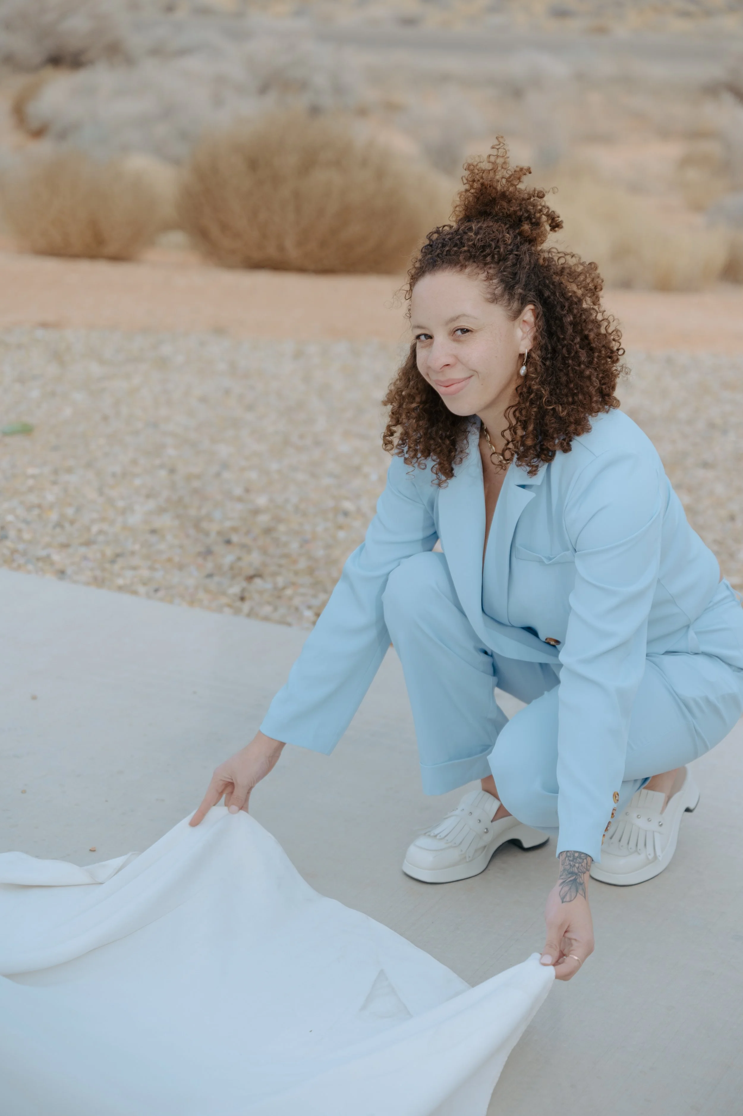Portrait of Tiffany Sweat, experience director and NASM-certified personal trainer, setting out linen at a gathering in Jackson Hole.
