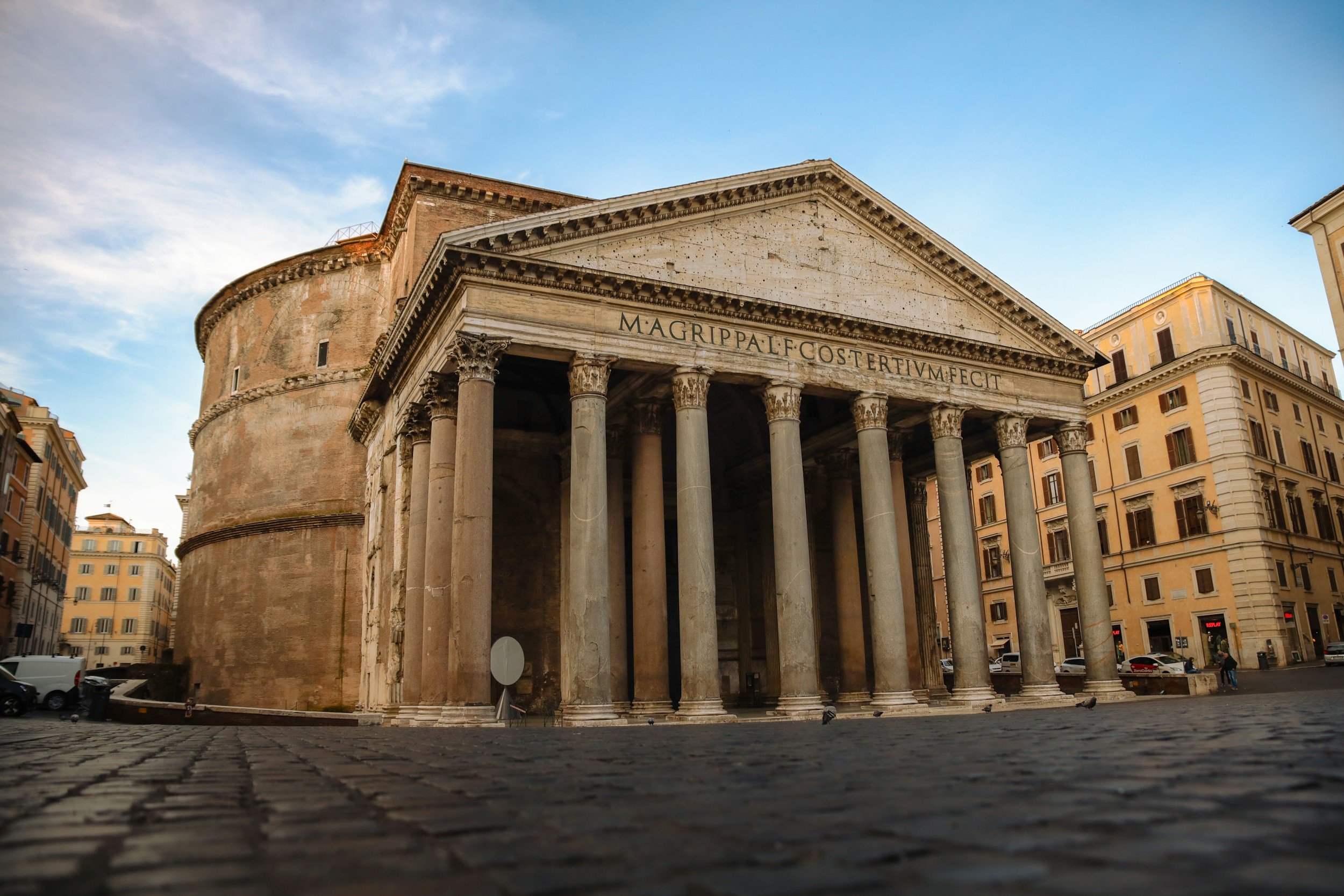 The Pantheon's columned portico on a cobblestone piazza in Rome