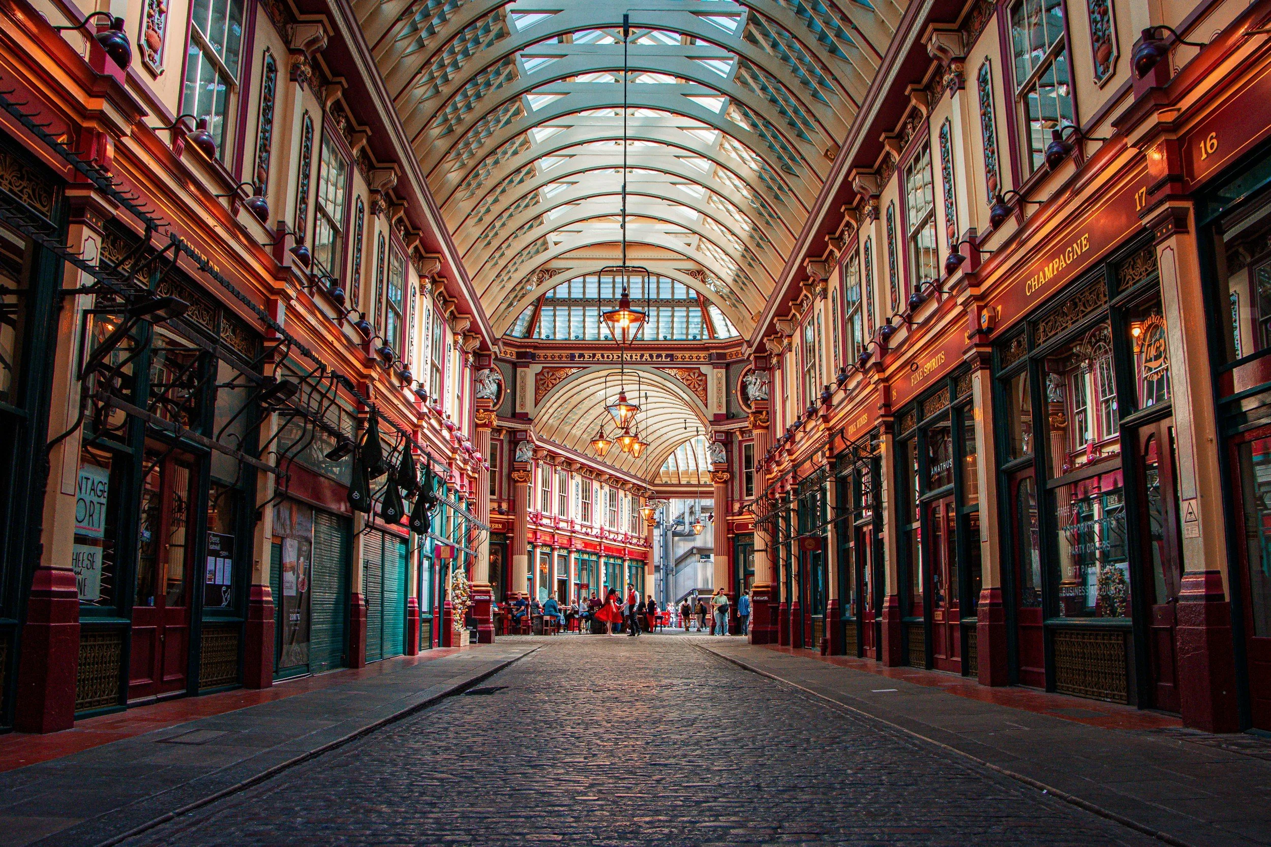 The ornate glass roof and painted Victorian storefronts of Leadenhall Market in the City of London