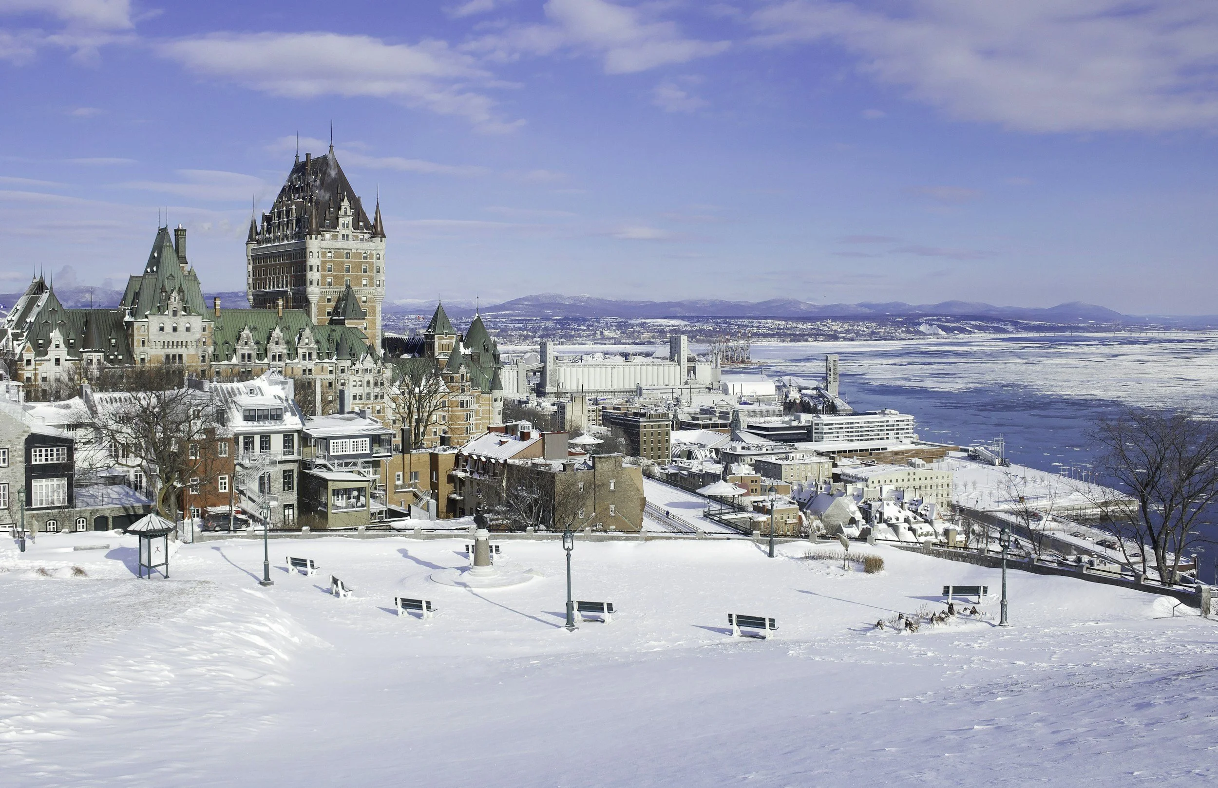 The Château Frontenac and Old Quebec under snow, above the icy St. Lawrence River on a sunny winter day