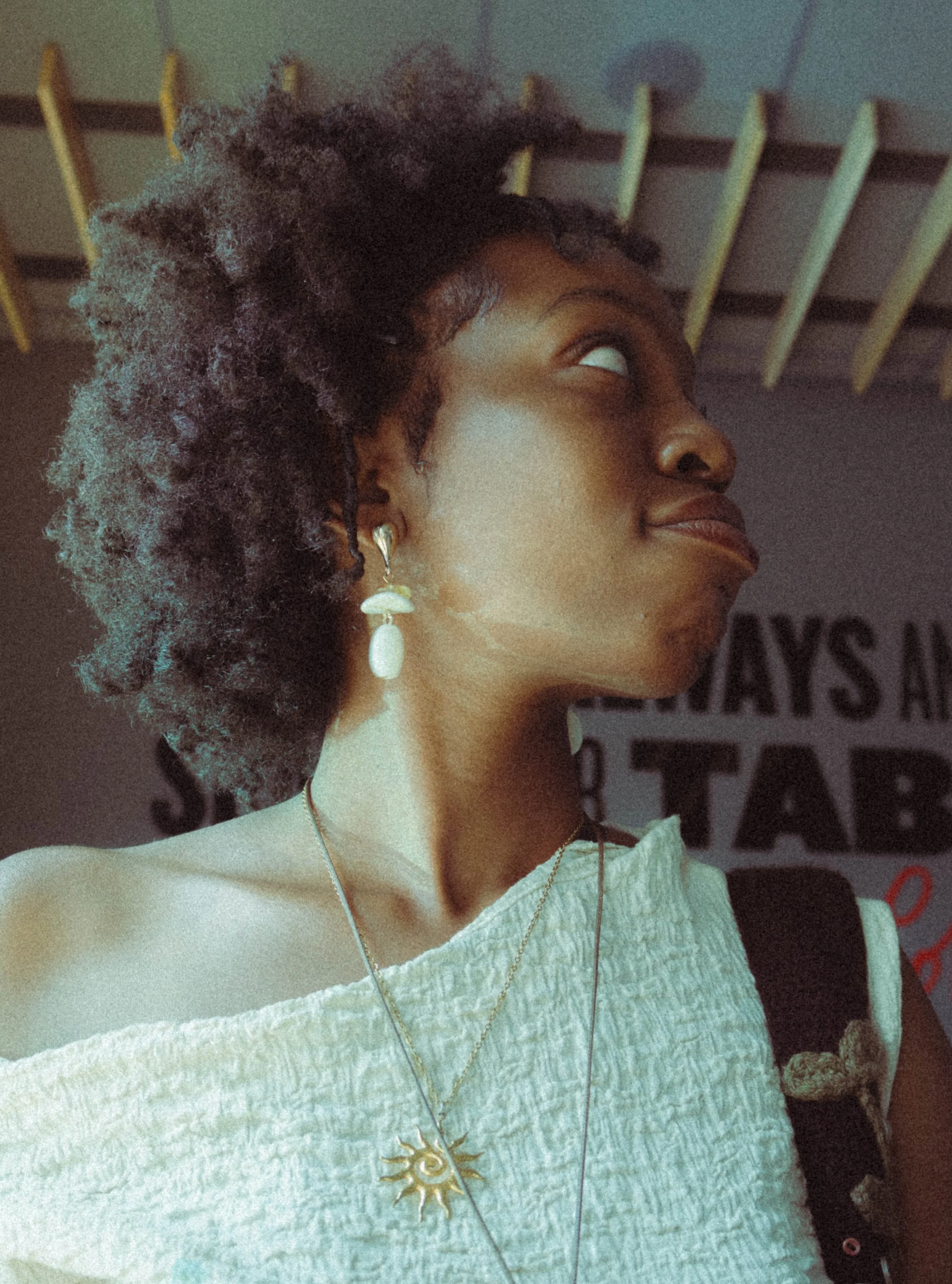 An editorial portrait photograph of a woman looking to her right taken by Kim Kambinda in Windhoek, Namibia.
