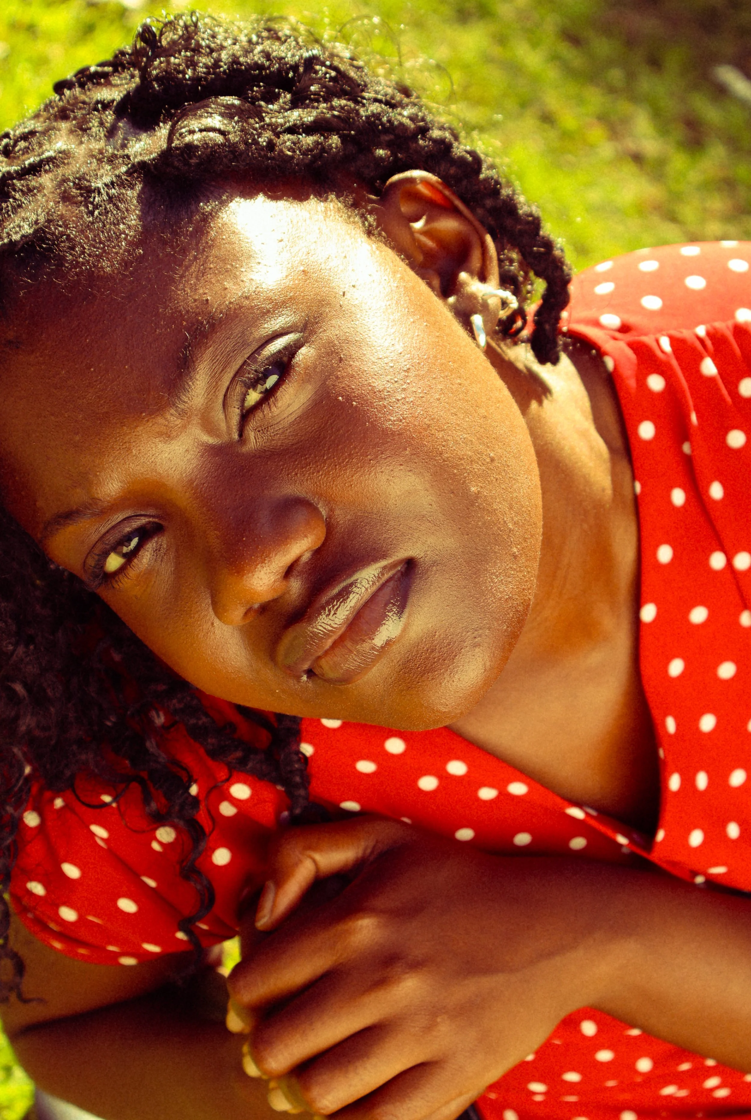 An editorial portrait photograph of Jane Simataa staring up at the camera while sitting on a chair taken by Kim Kambinda in Windhoek, Namibia.