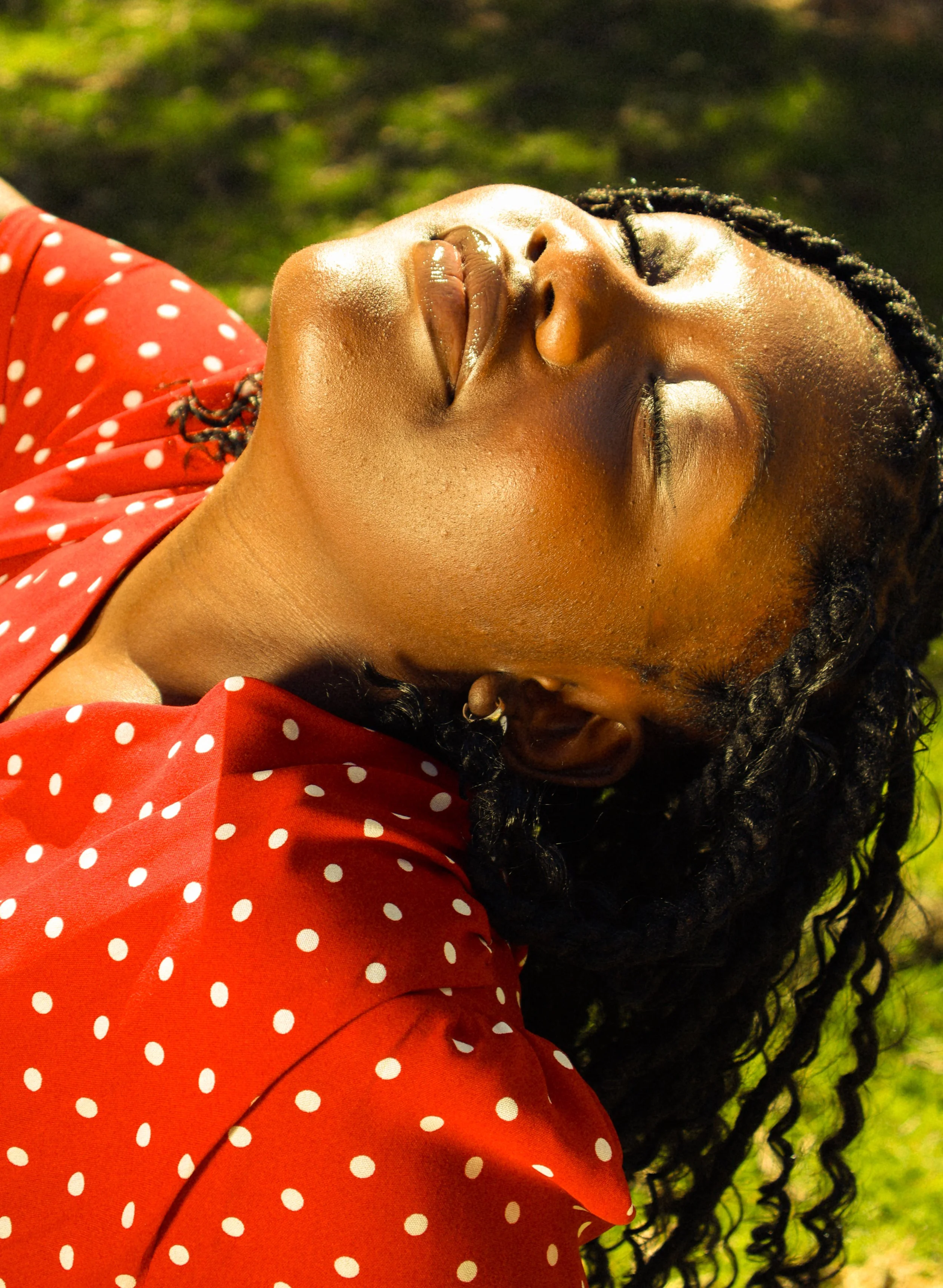 An editorial portrait photograph of Jane Simataa facing up at the sky with her eyes closed while sitting on chair taken by Kim Kambinda in Windhoek, Namibia.