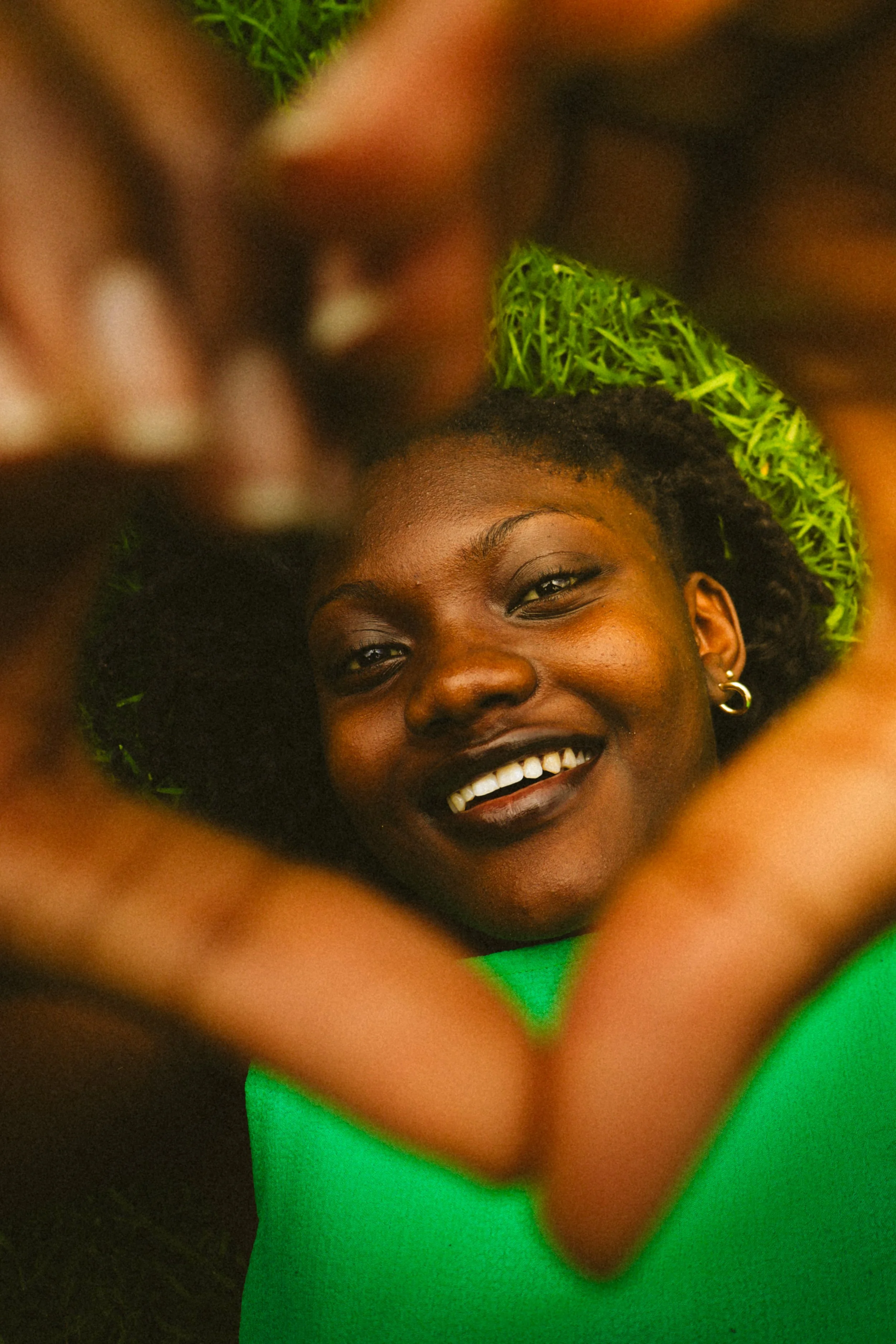 An editorial portrait photograph of Jane Simataa making a heart shape with her fingers taken by Kim Kambinda in WIndhoek, Namibia.