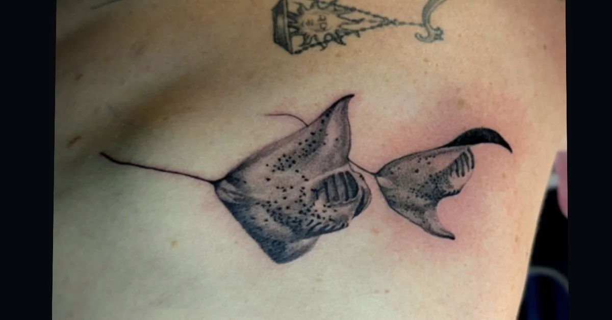 Black-and-gray manta ray tattoo with spotted wings and a long tail
