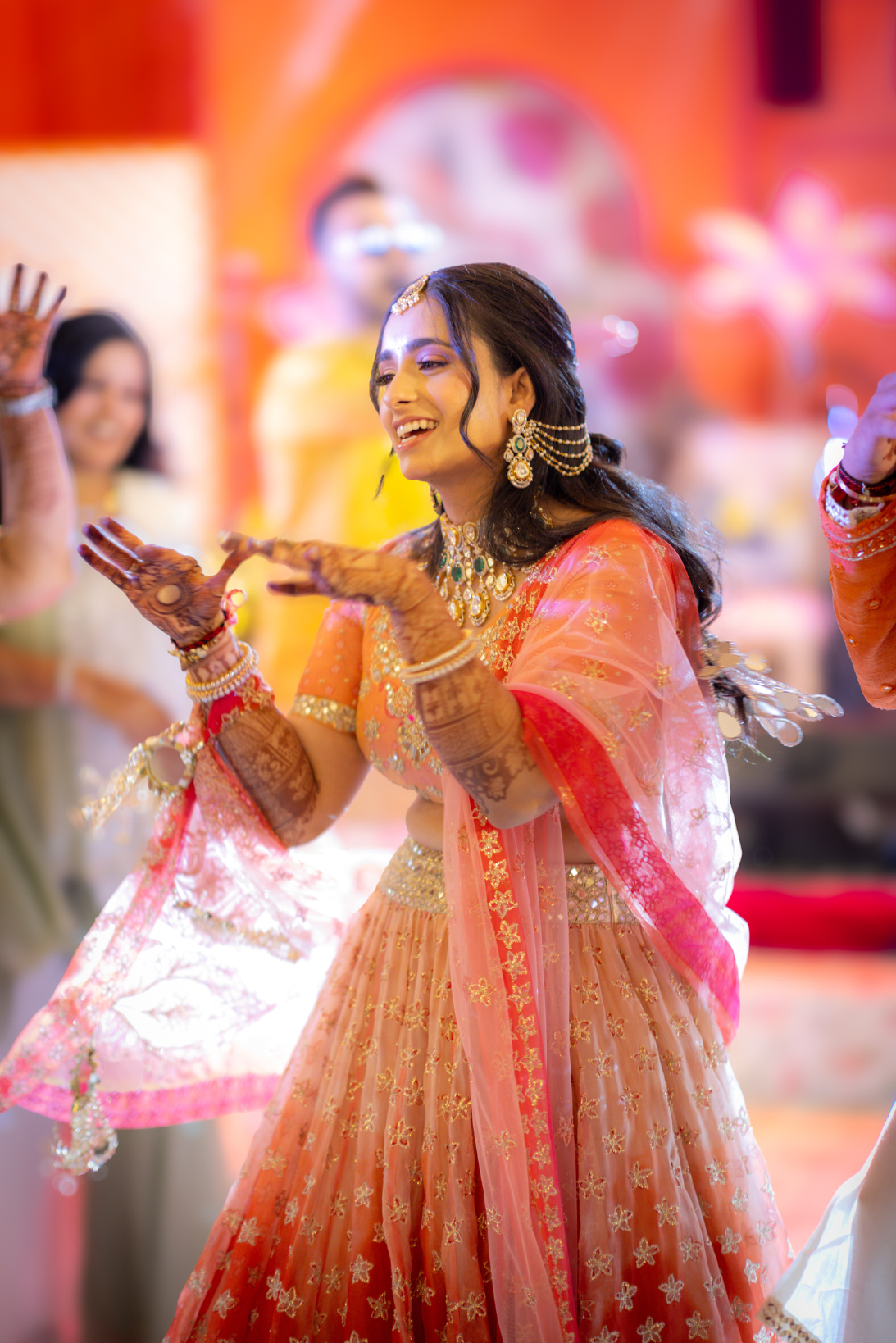 Woman in traditional Indian attire dancing at a celebration.