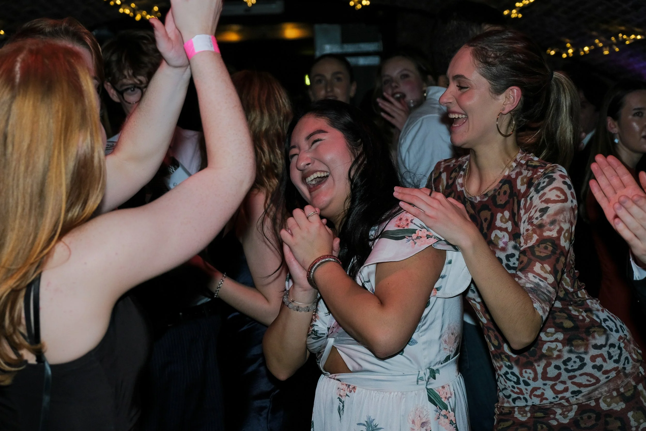 Group of women smiling and celebrating at a party or event.
