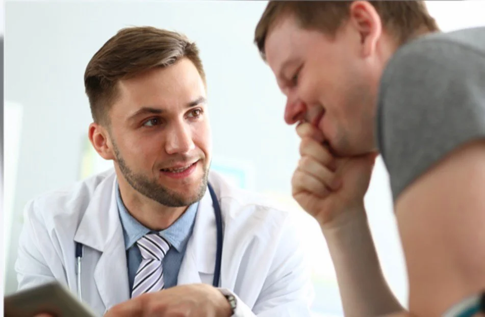 Doctor with white coat and stethoscope talking with a patient