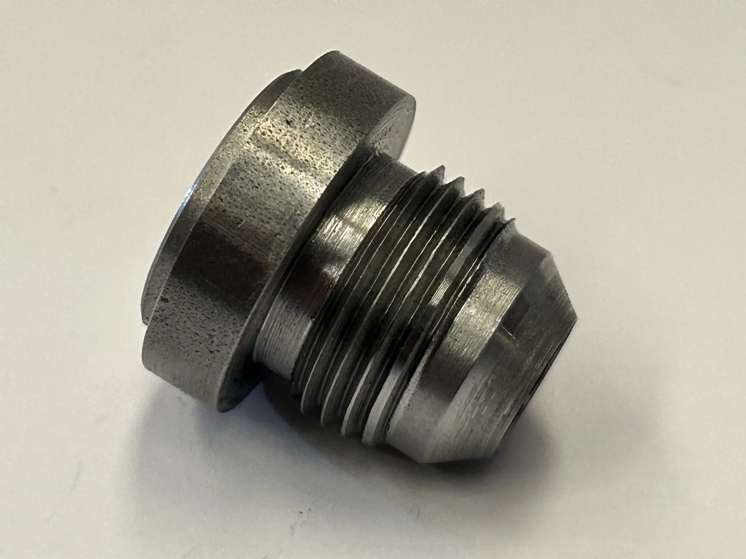Side view of an AN-10 JIC male weld-on fitting CNC machined from EN8 steel, showing the external thread, 37-degree cone and weld-on flange.