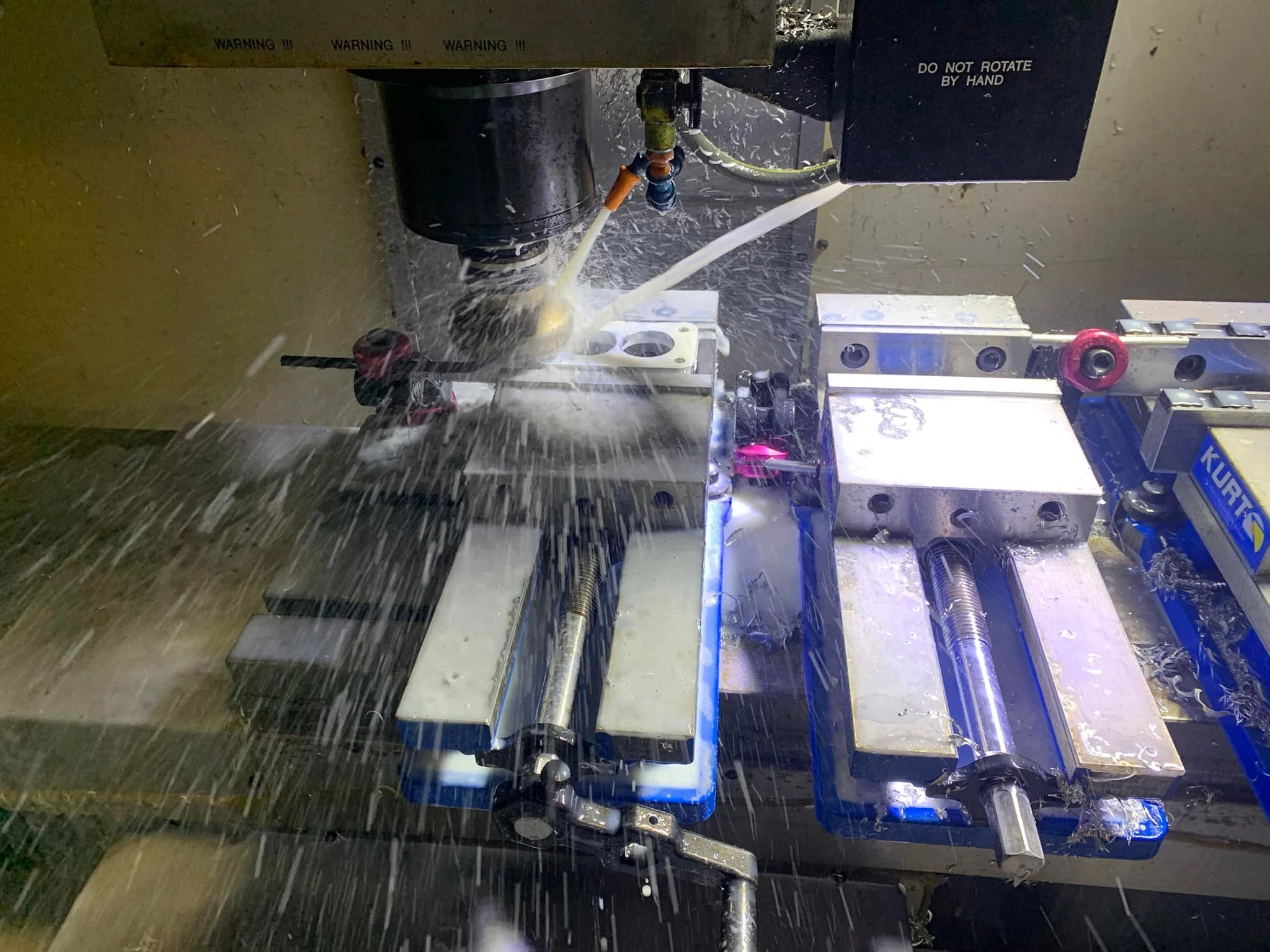 Haas VF2 CNC milling machine operating at the PlazCutz workshop in Lancashire, machining metal components using precision milling equipment.
