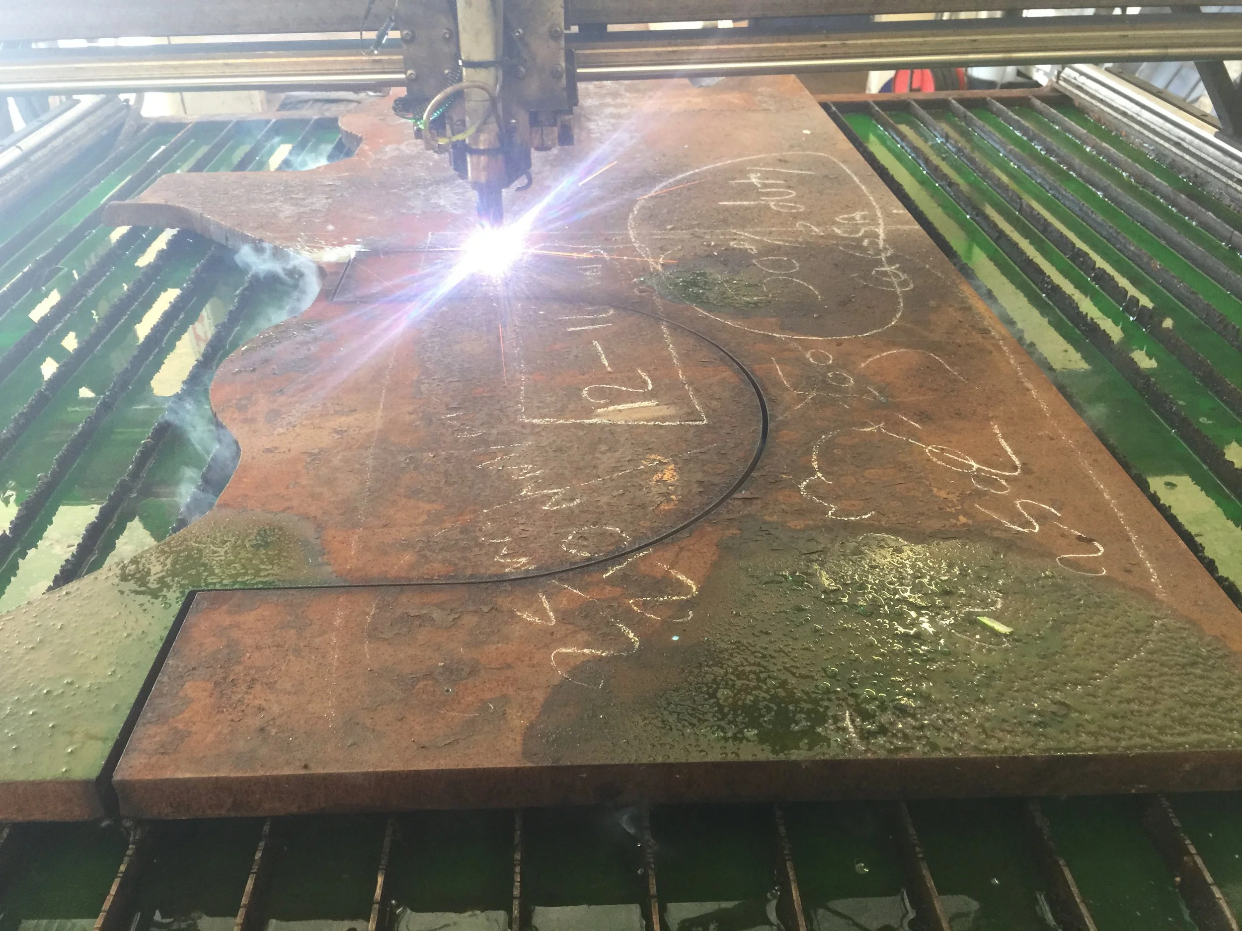 PlazCutz CNC plasma cutting a large, thick steel plate using Hypertherm plasma technology, producing a bespoke curved steel profile at our engineering workshop in Morecambe, Lancashire.