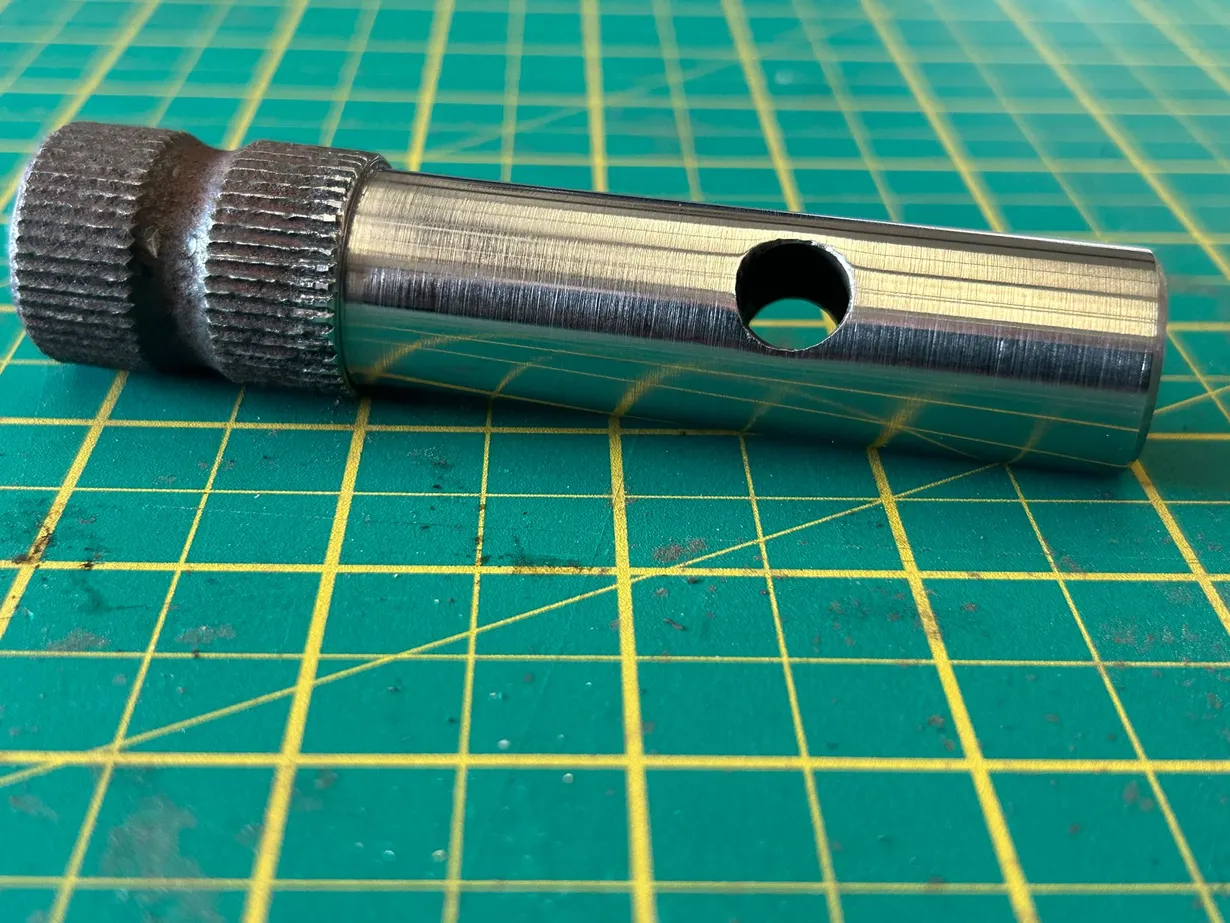 Repaired steel shaft showing its machined surface, splined section and cross-drilled hole following engineering work at PlazCutz.
