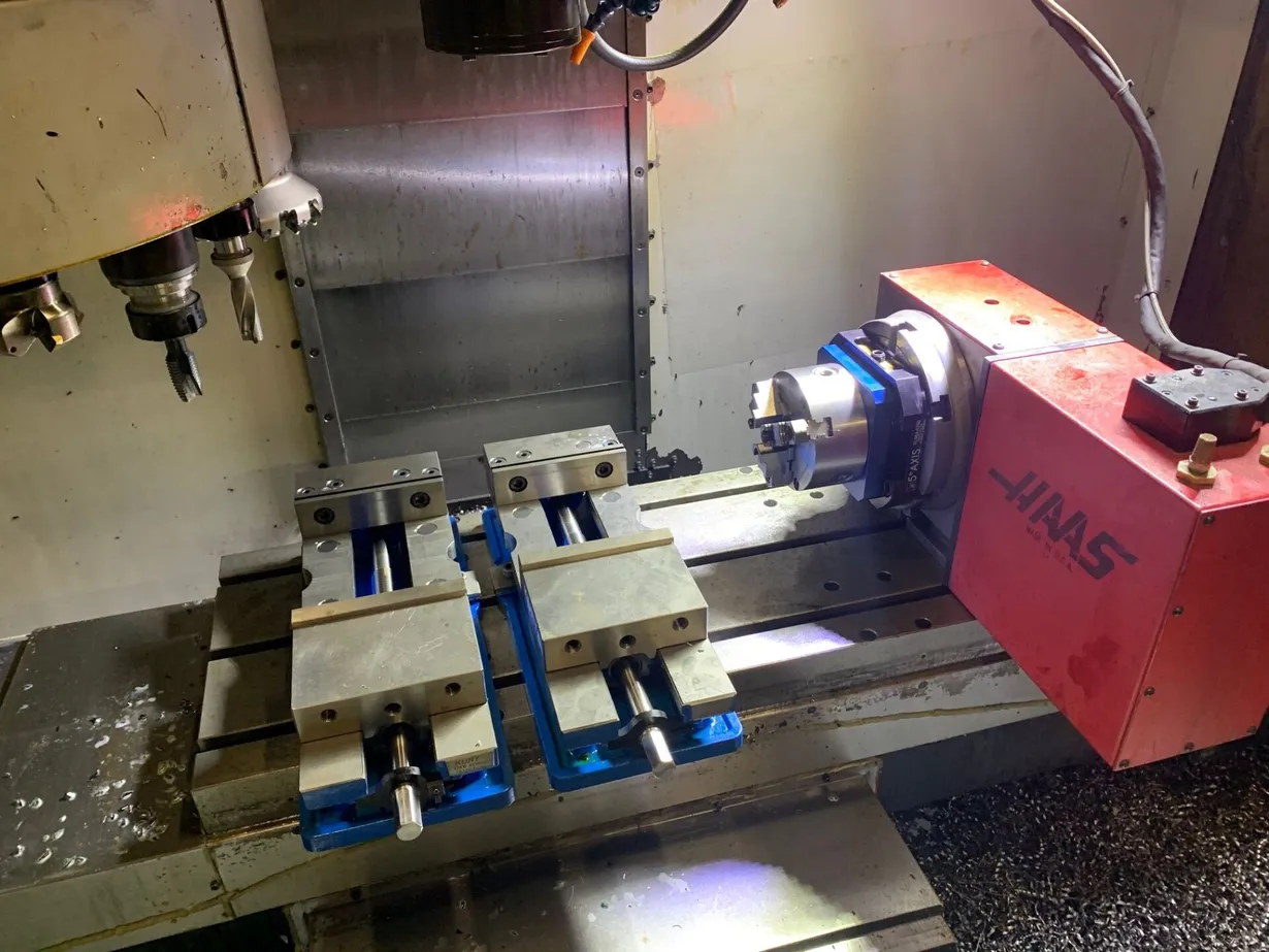 Haas VF2 CNC milling machine with fourth-axis rotary table and precision engineering work holding in Lancashire.