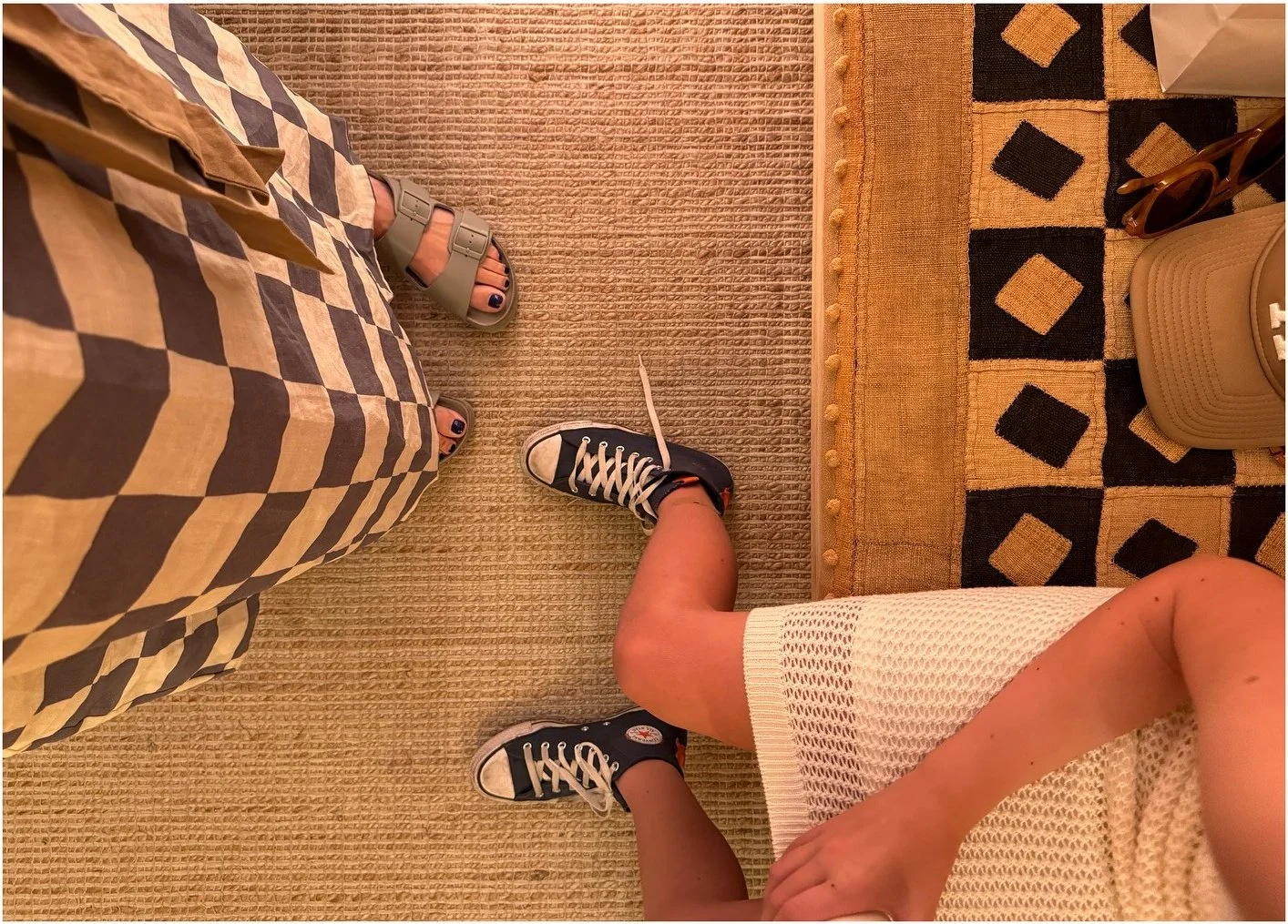 Patterned textiles beside woven flooring in a fitting area