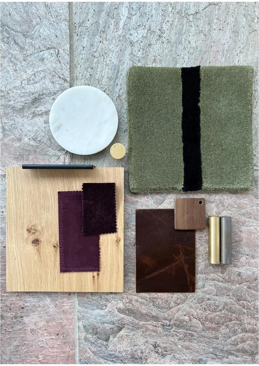 Material palette with green textiles pale wood stone and brass hardware