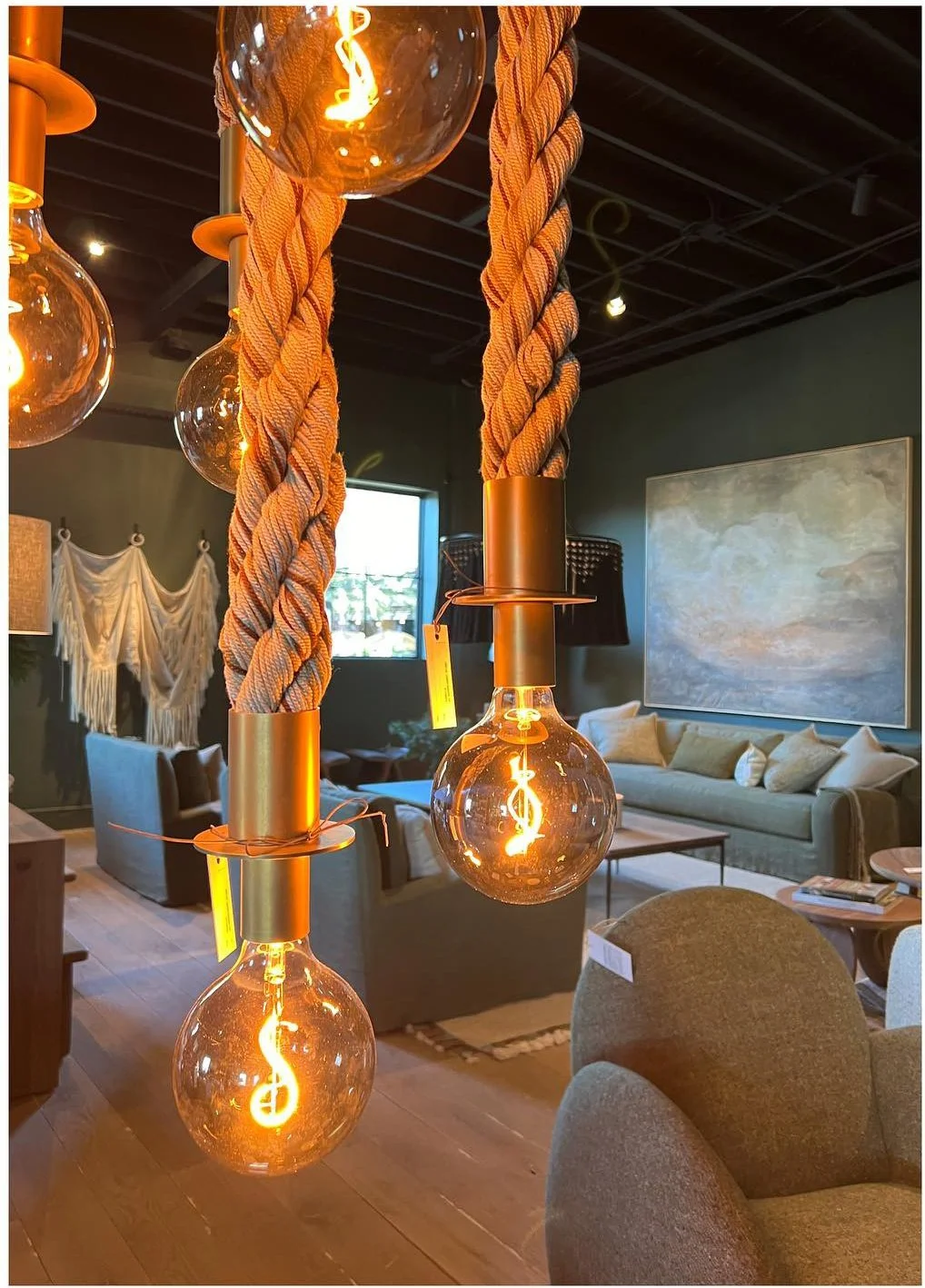 Amber glass pendant lights above sculptural timber furnishings