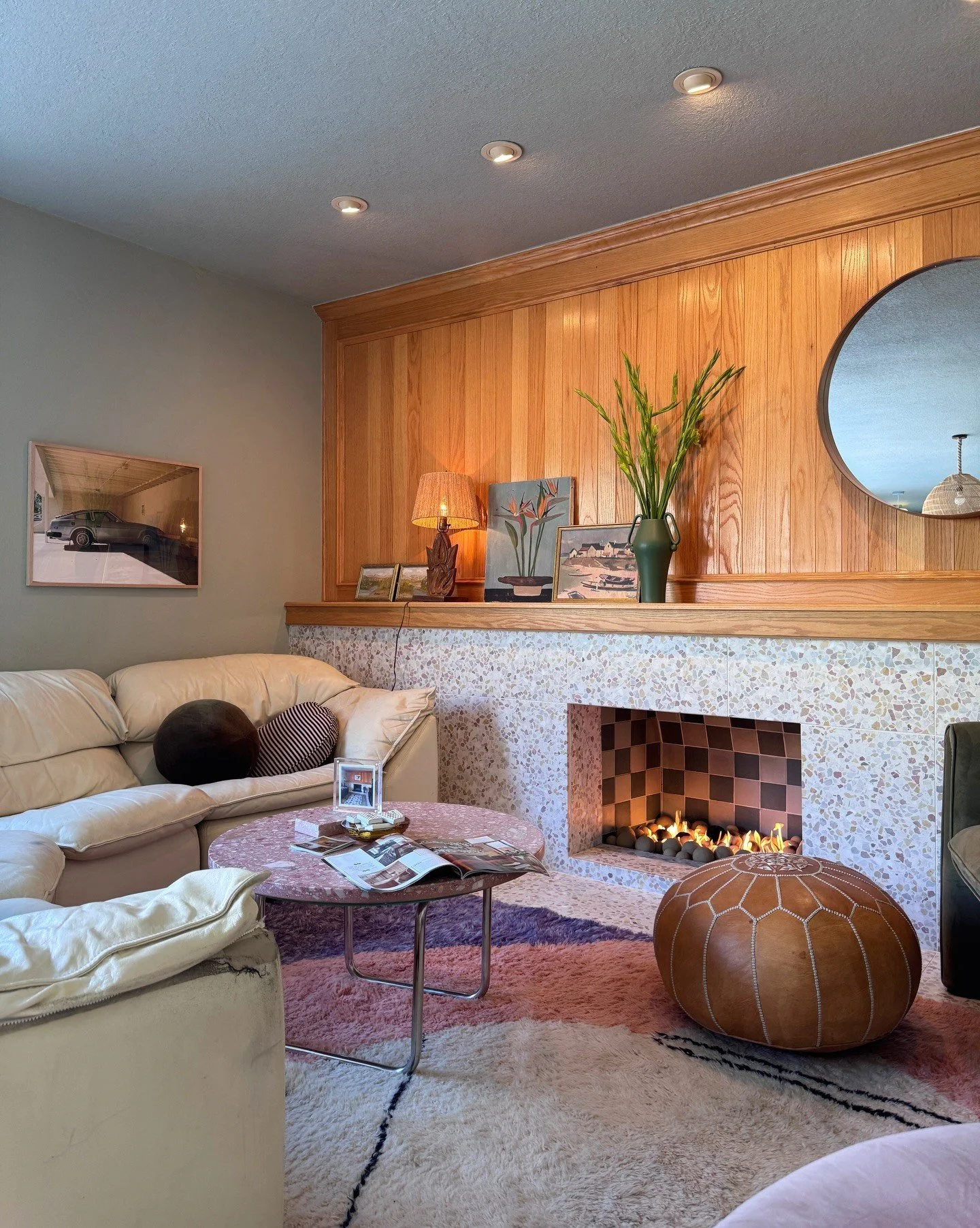 Living room with a pale sofa and wood fireplace wall