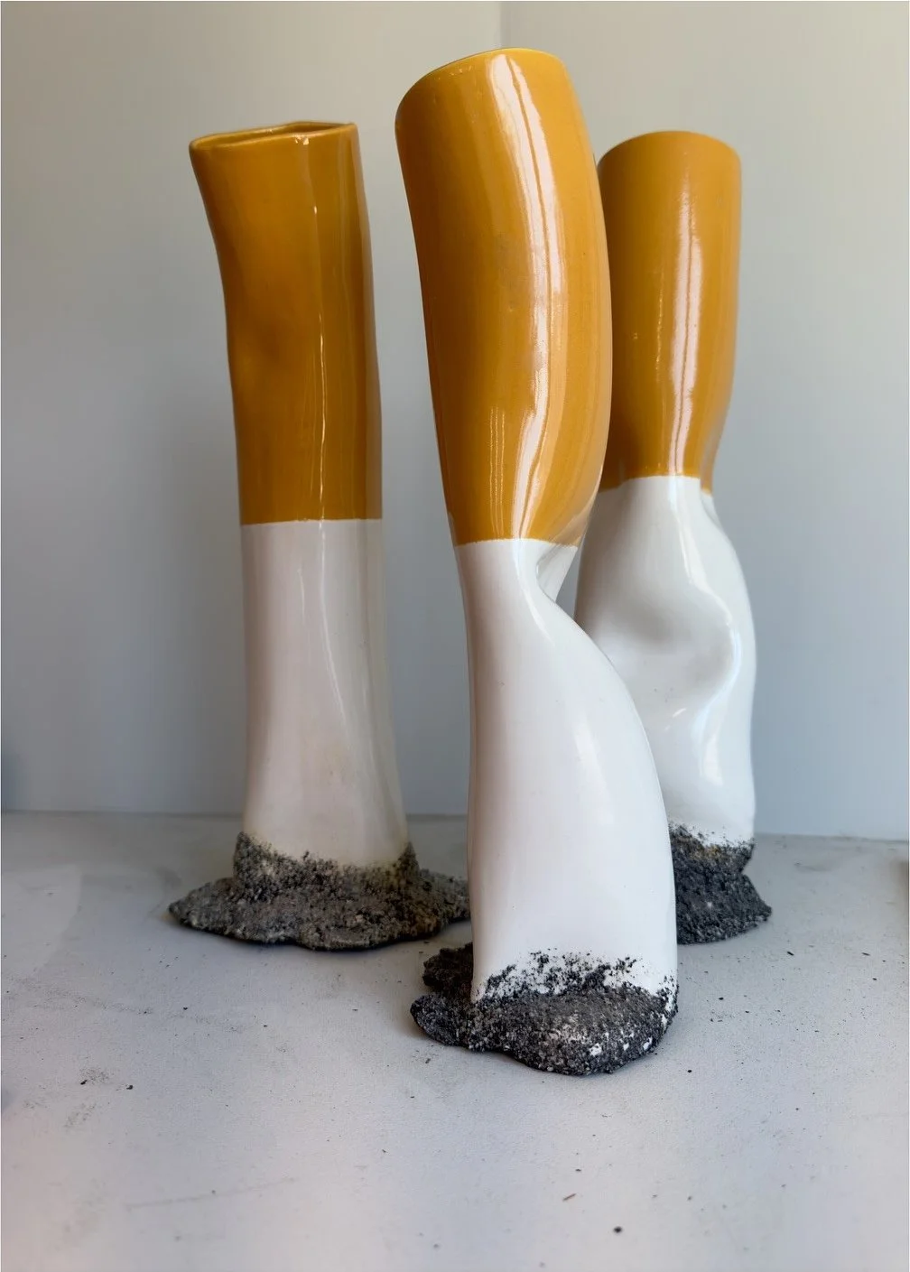 Tall sculptural ceramic vessels with ochre glazed tops