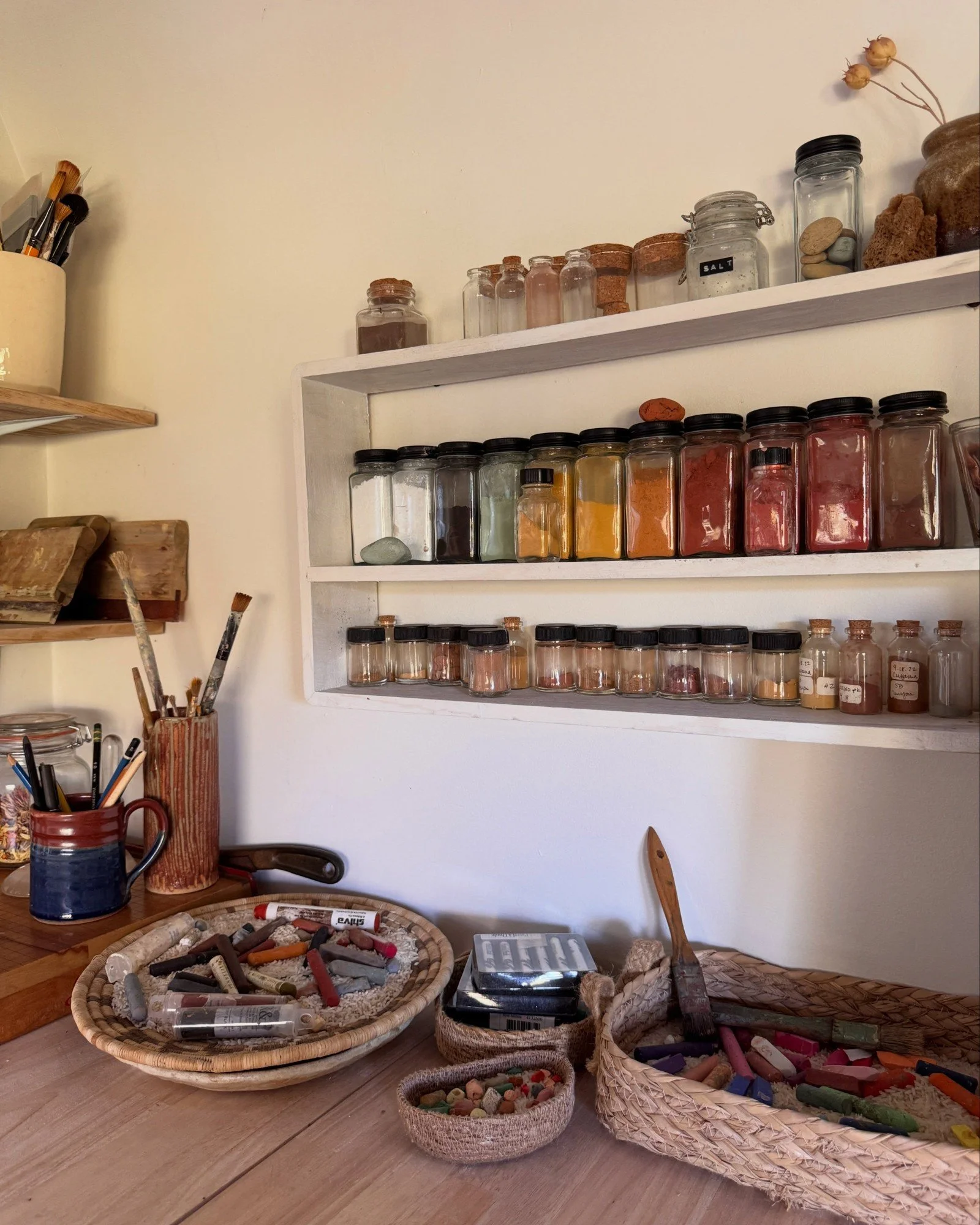 Open kitchen shelves with spice jars and a wood counter