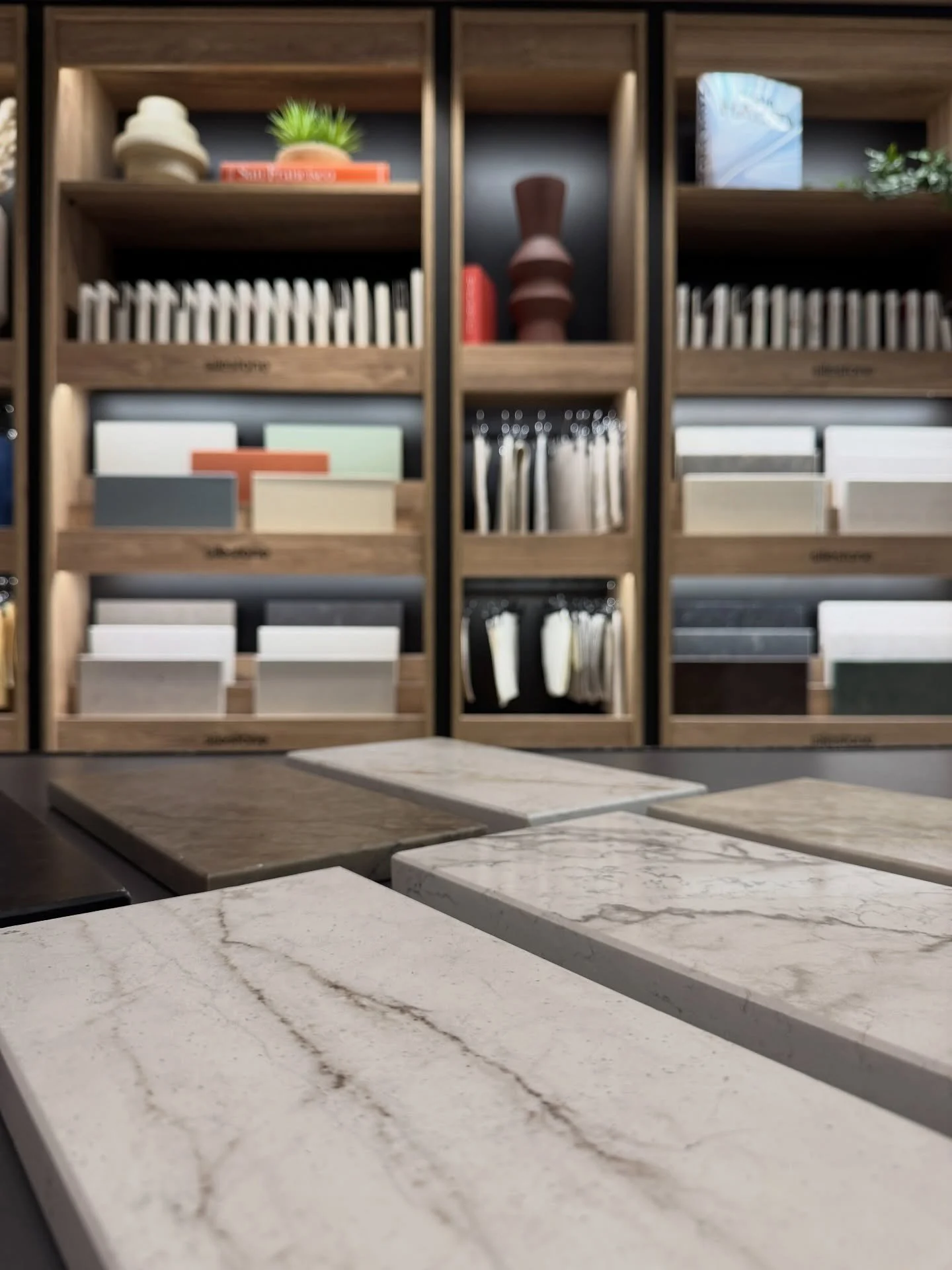 Material showroom with sample boards beneath styled wood shelves