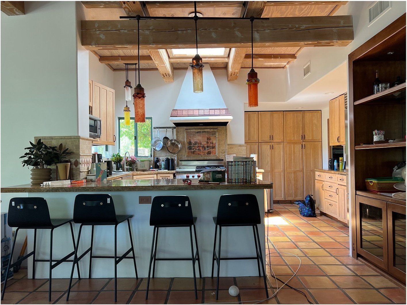 Original kitchen with green island and hanging pendant lights