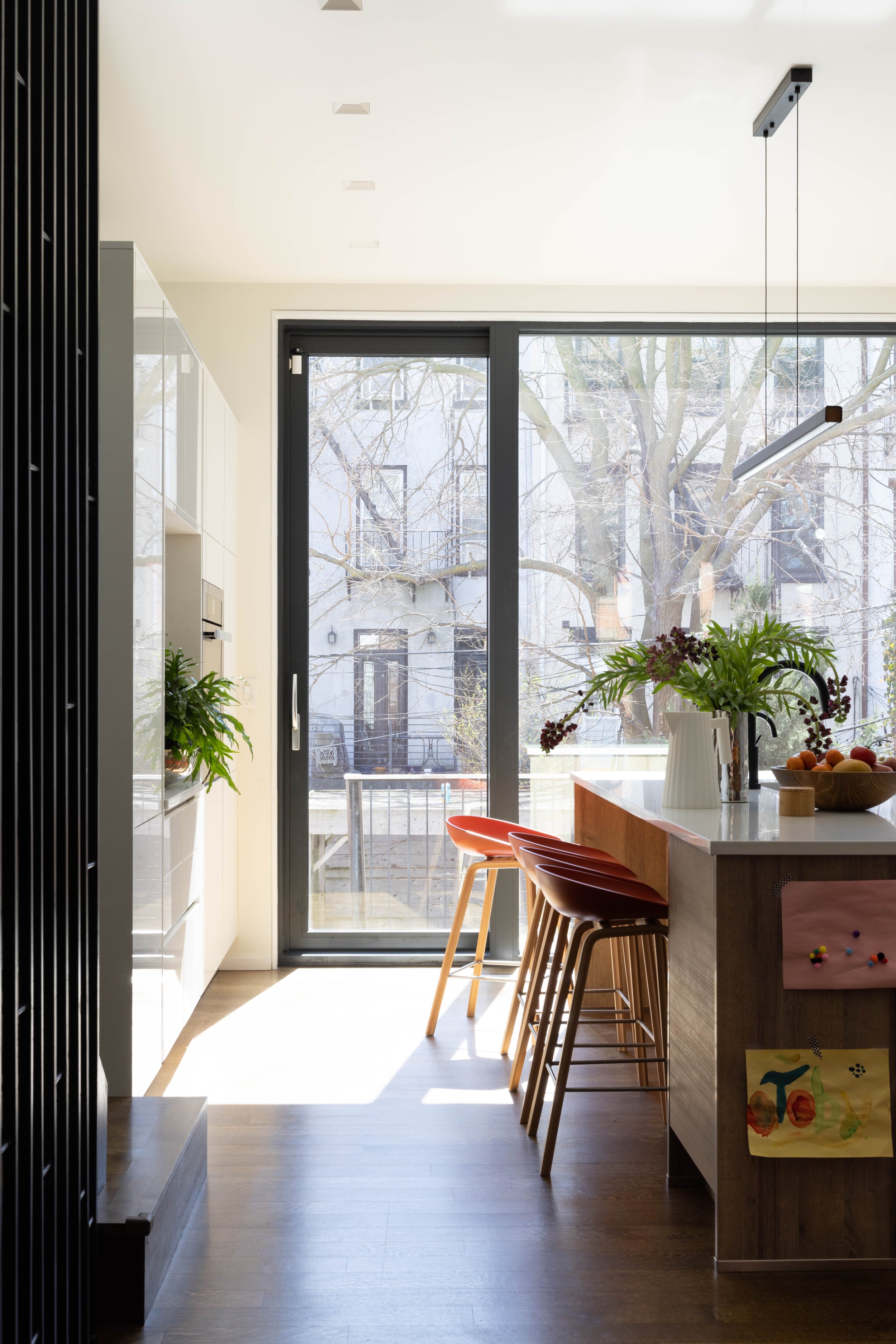Kitchen with wood island seating and glass doors to the garden.