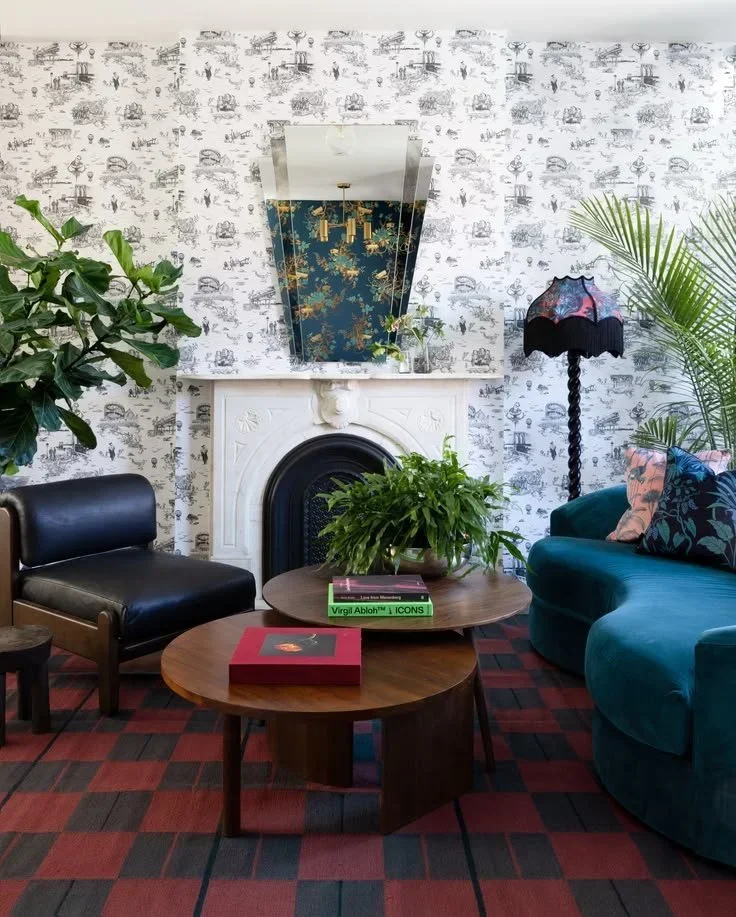  No Sleep Till Brooklyn ↗  Toile wallpaper, teal upholstery, and a checked rug.