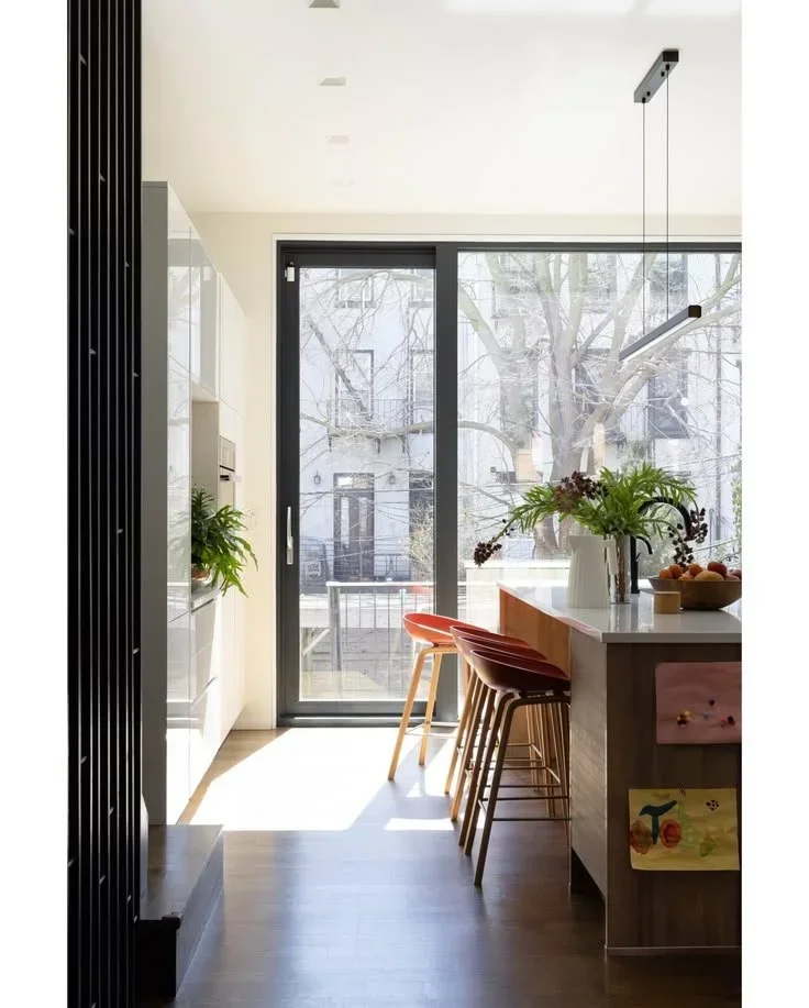  No Sleep Till Brooklyn ↗  A wood kitchen island opens toward the garden.