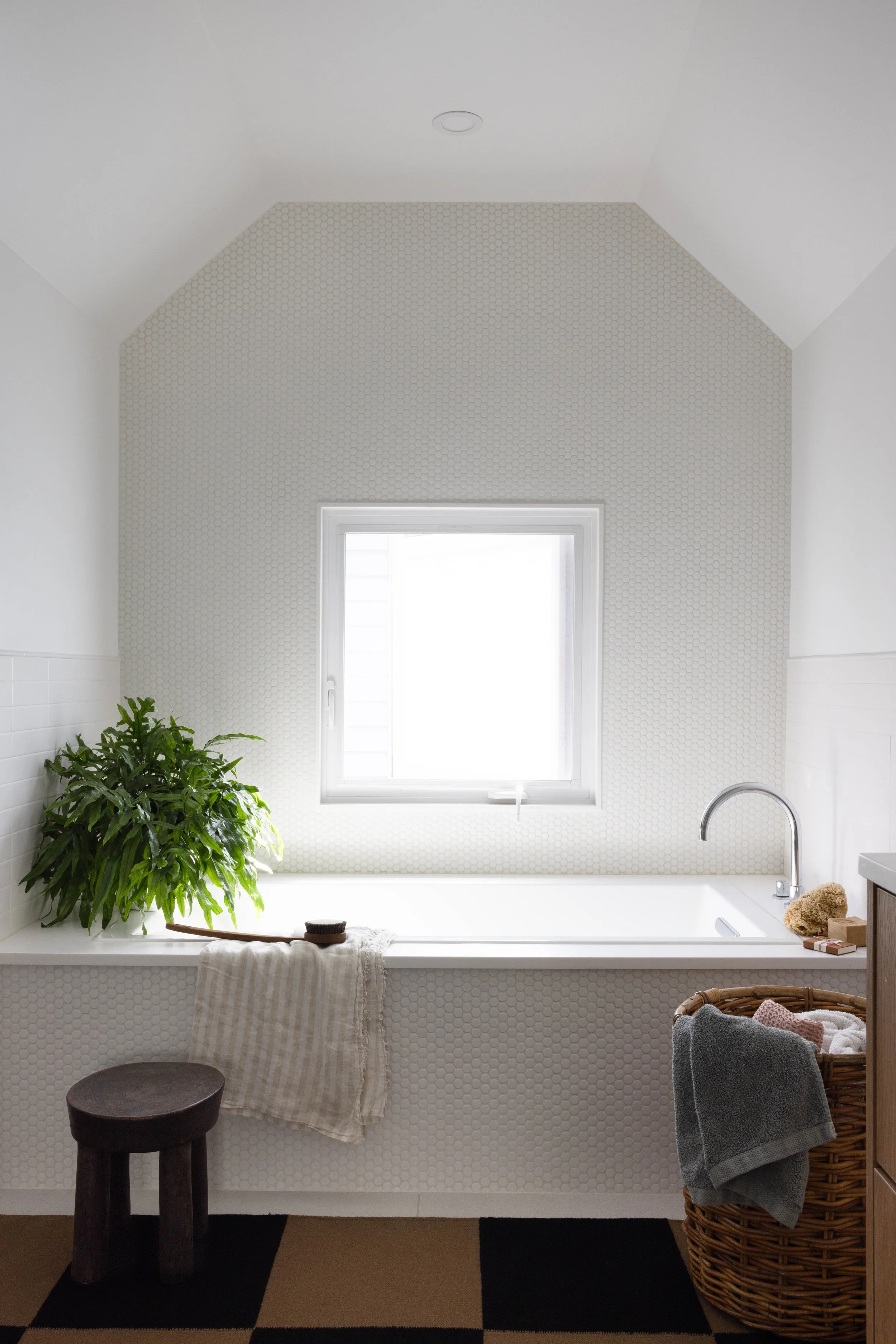 Desk beneath a window in a pale gray room.