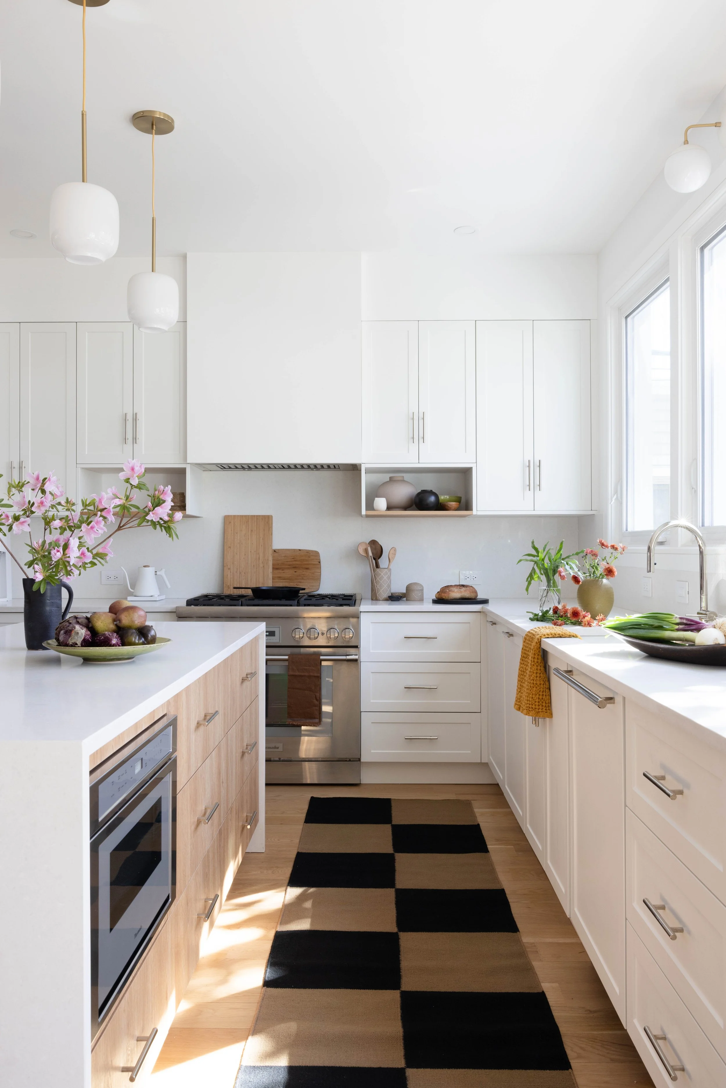 White kitchen cabinetry with wood counters and a checkerboard floor.