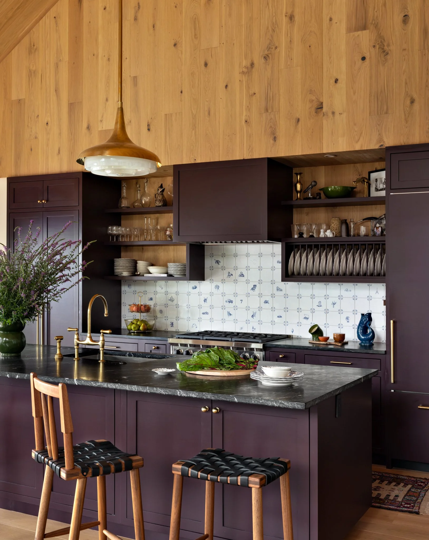 Kitchen with a plum island and blue-and-white tile backsplash.