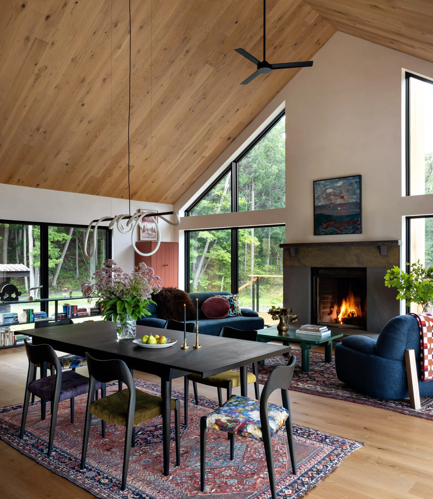 Dining area and living room beneath a vaulted wood ceiling.