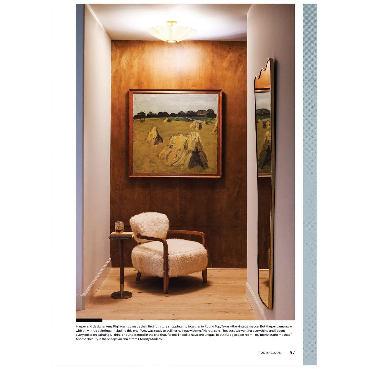 Magazine feature showing a wood-paneled niche with framed art and a sculptural chair