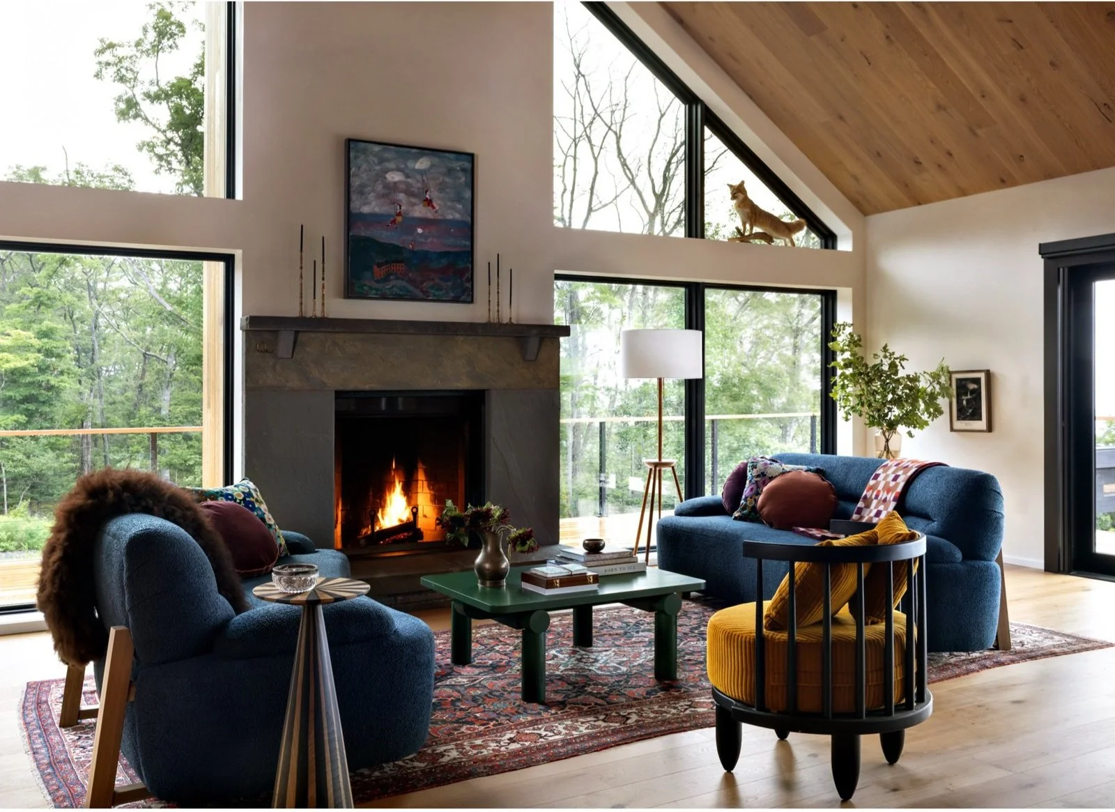 Open living and dining room beneath a pitched wood ceiling