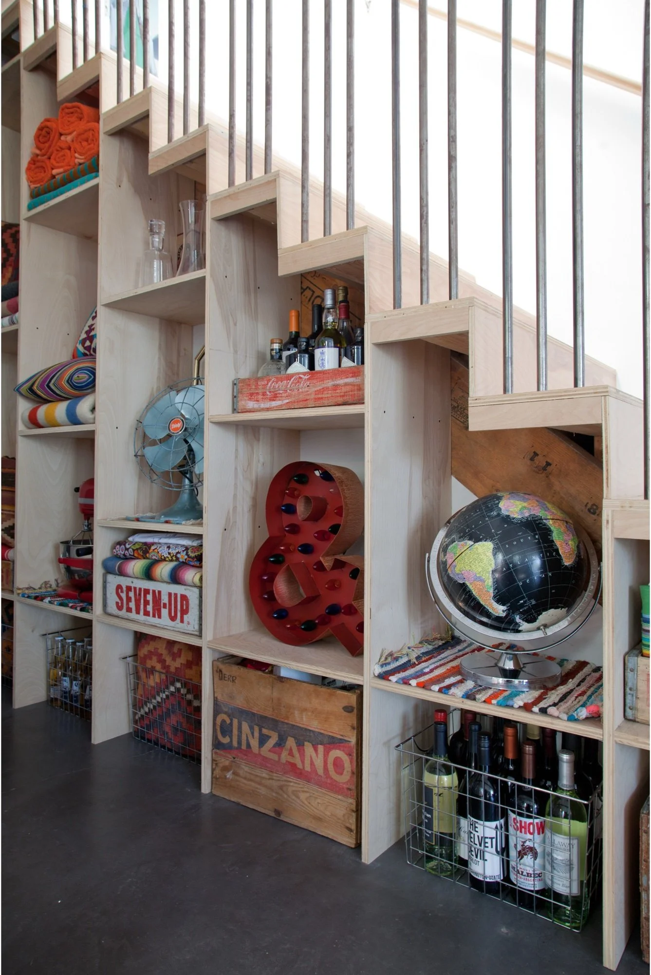 Wood staircase with colorful open storage beneath the treads