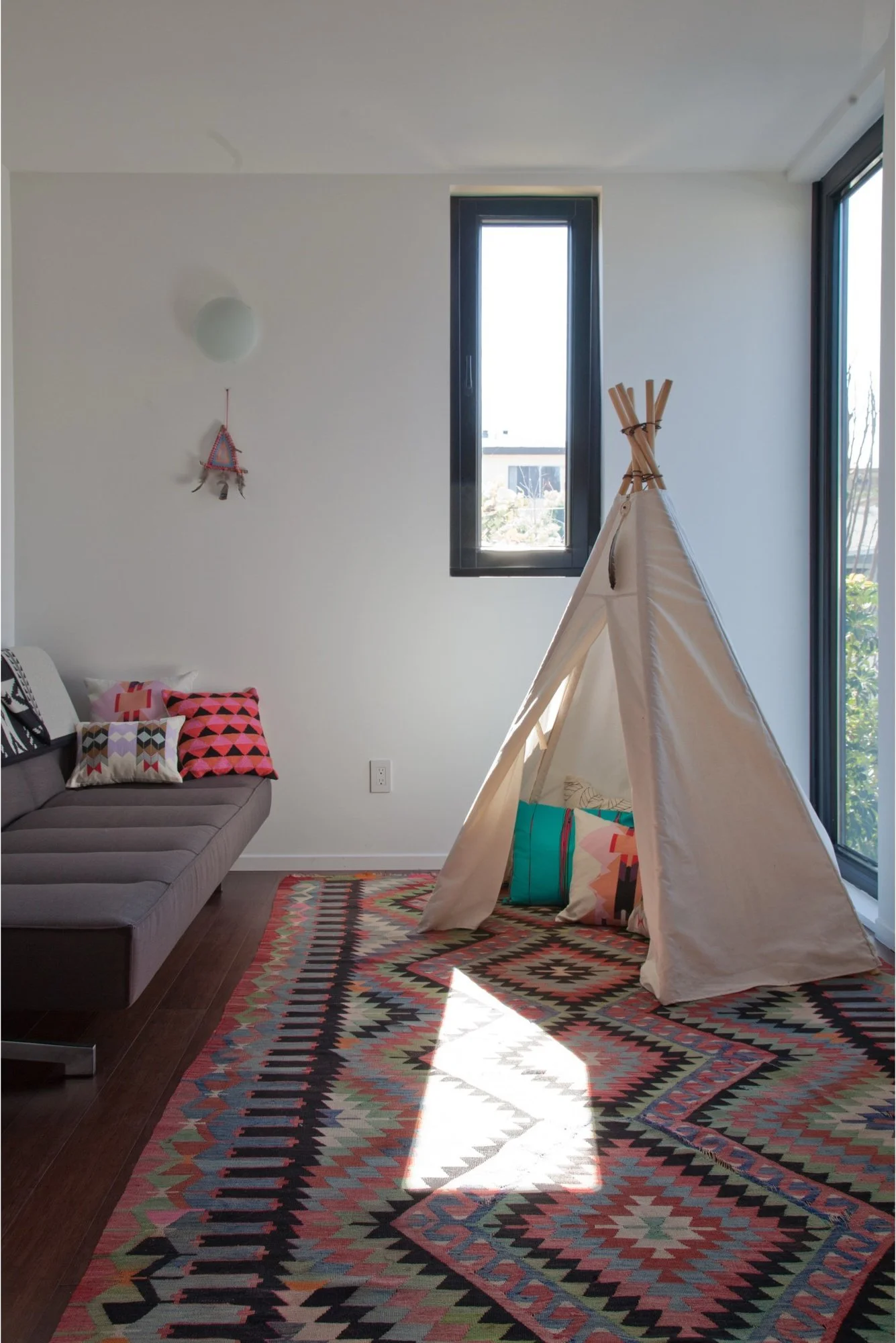 Child's room with a canvas play tent and patterned rug