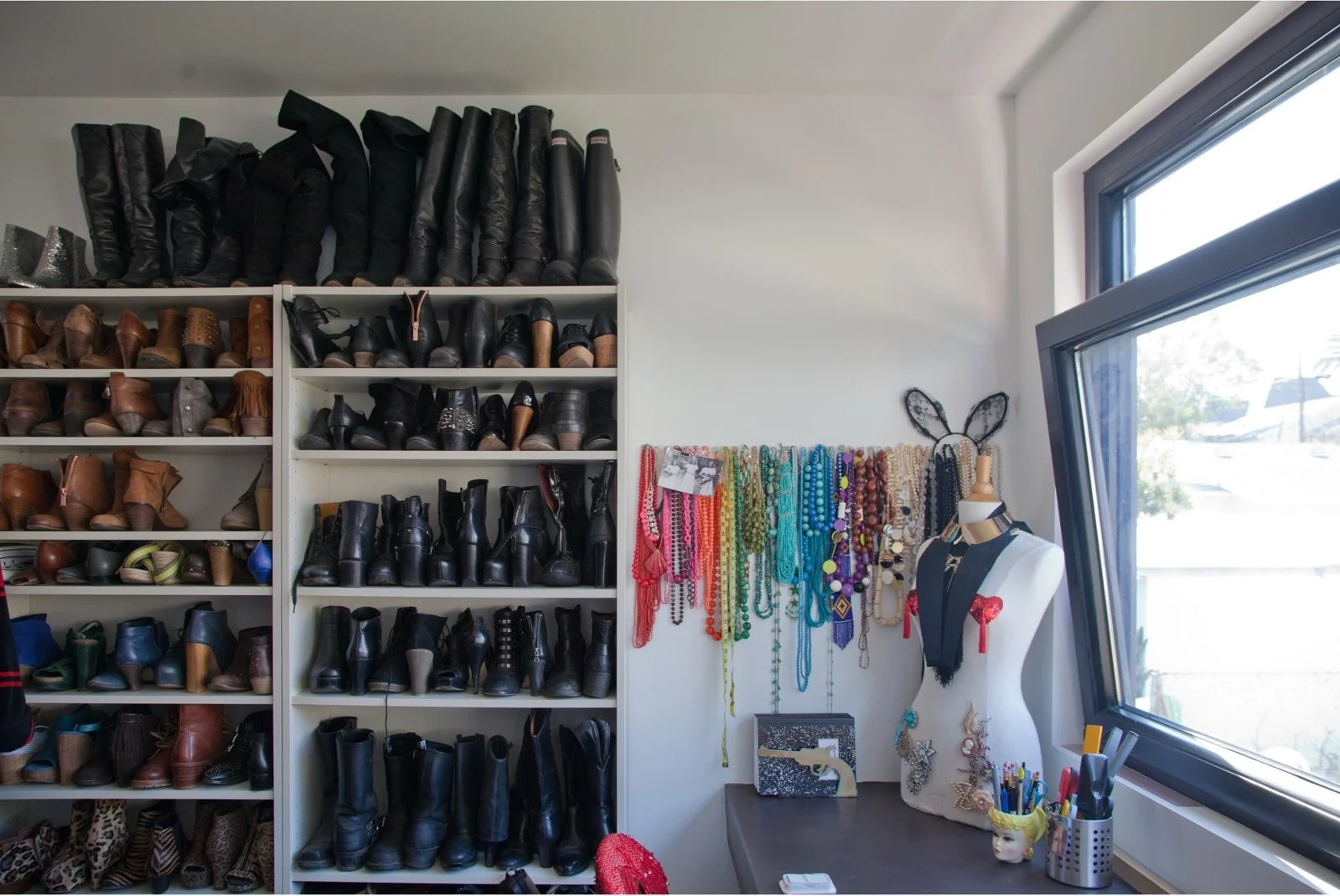 Open shoe storage beside a bright dressing-room window