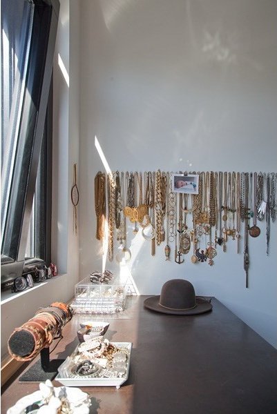 Jewelry and accessories arranged on a wood dressing table
