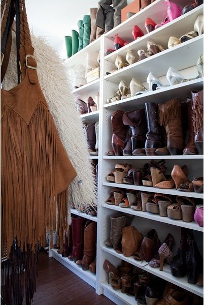 White shoe shelves and hanging clothing in a dressing room
